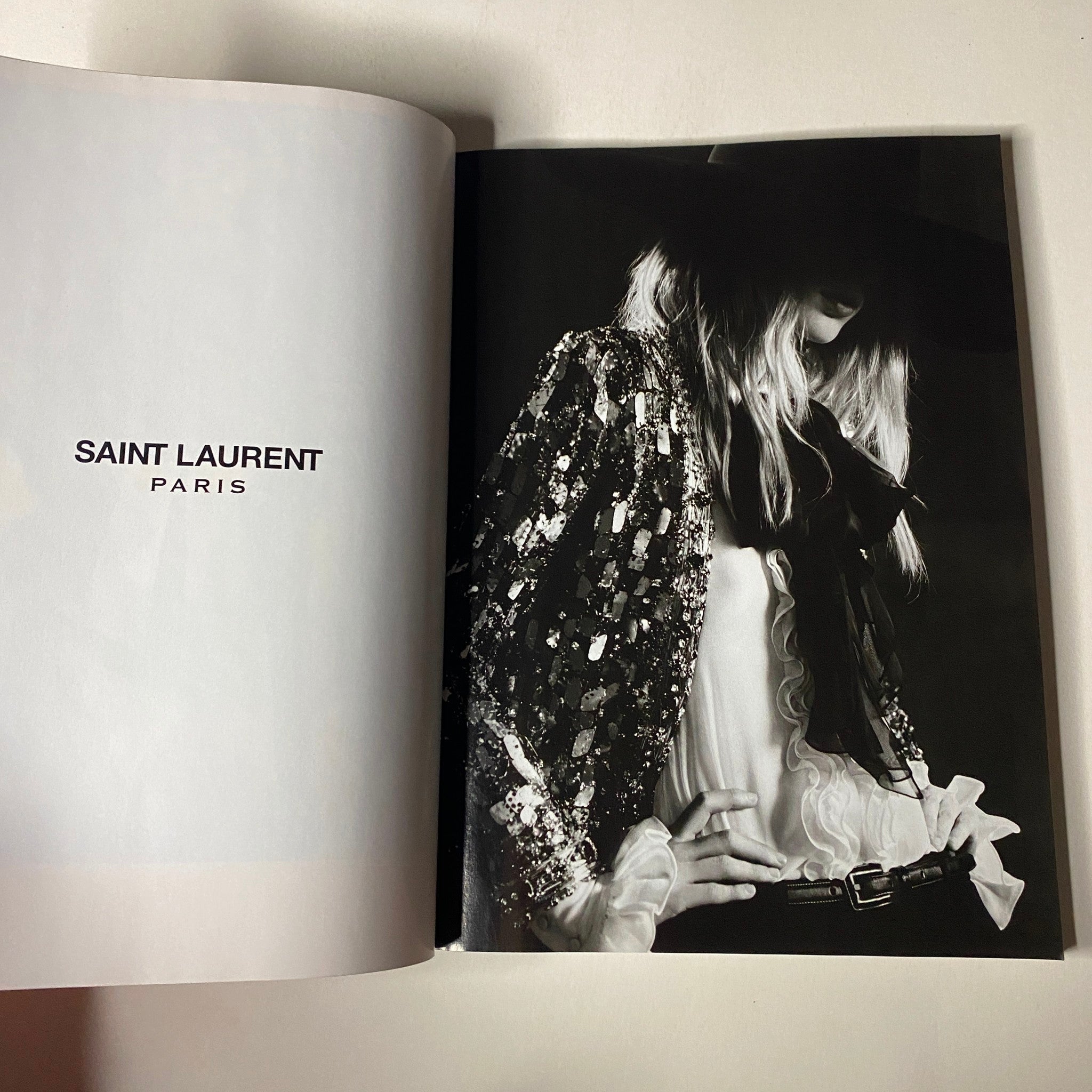 Vogue Magazine February 2013 showcasing a high-fashion editorial for Saint Laurent Paris with a model in a sequined jacket and wide-brim hat.
