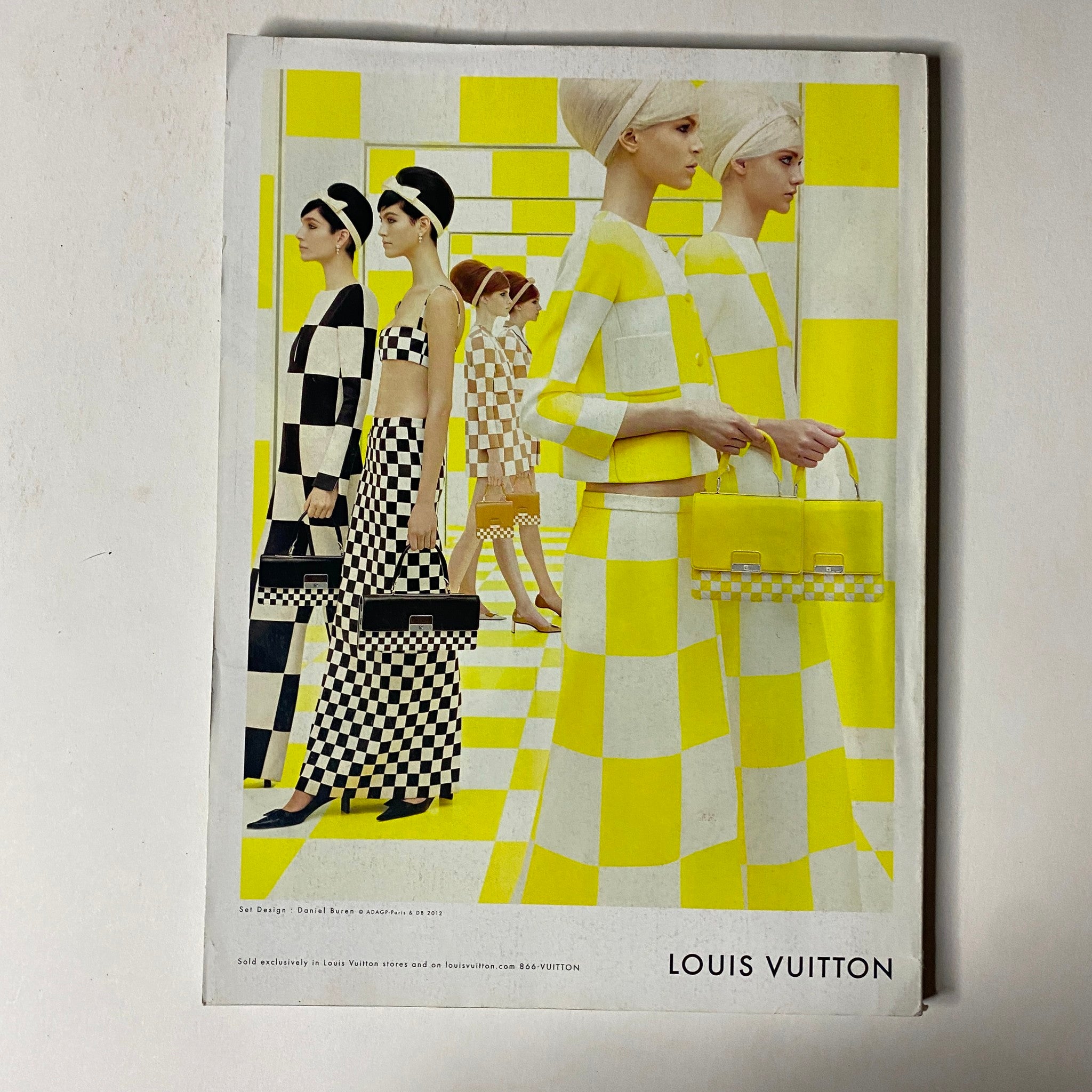 Vogue Magazine February 2013 featuring a vibrant Louis Vuitton advertisement with models in checkerboard patterns and bright yellow backgrounds, illustrating bold fashion choices.