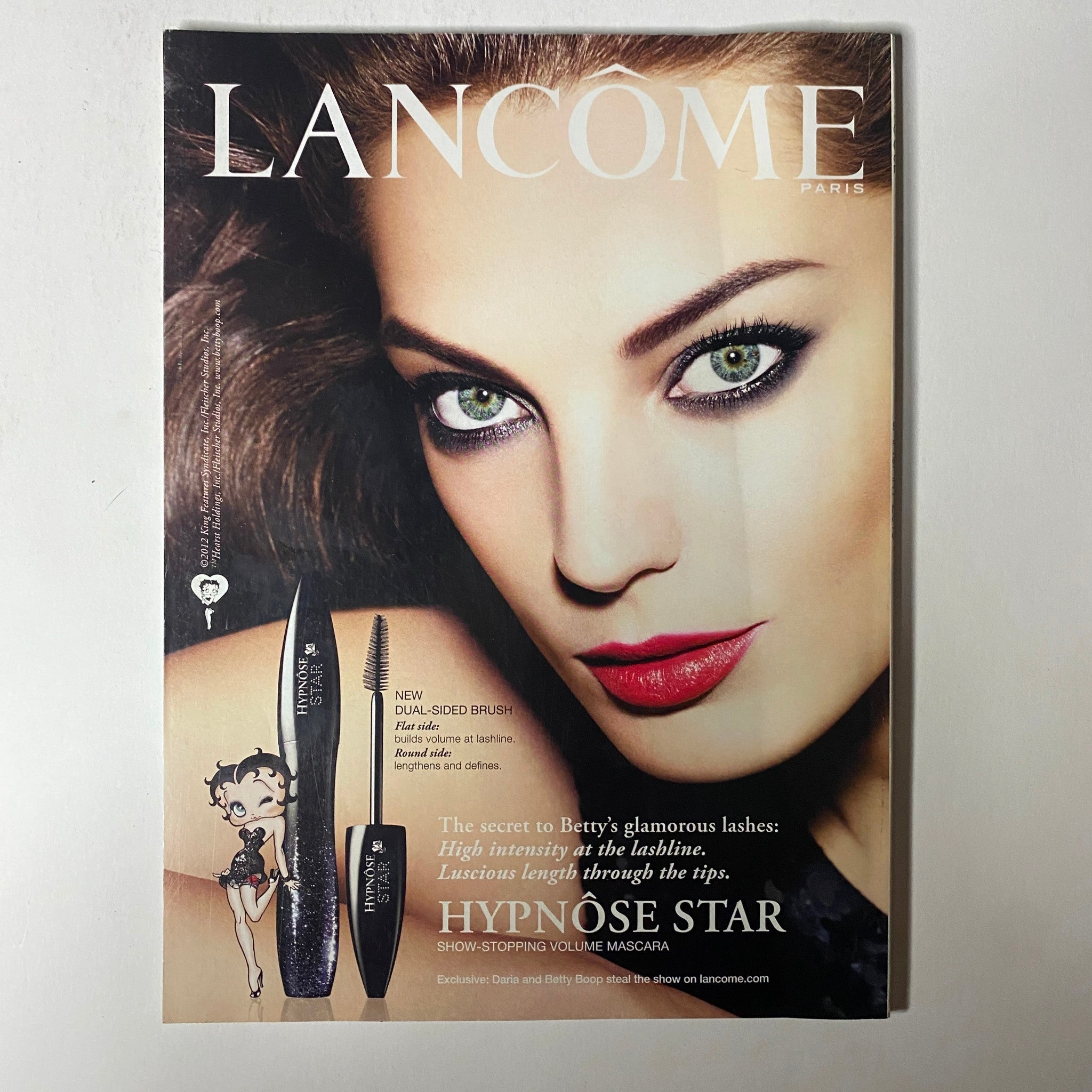 Vogue Magazine January 2013 advertisement for Lancôme showcasing a model with stunning makeup, emphasizing beauty products and glamorous looks.