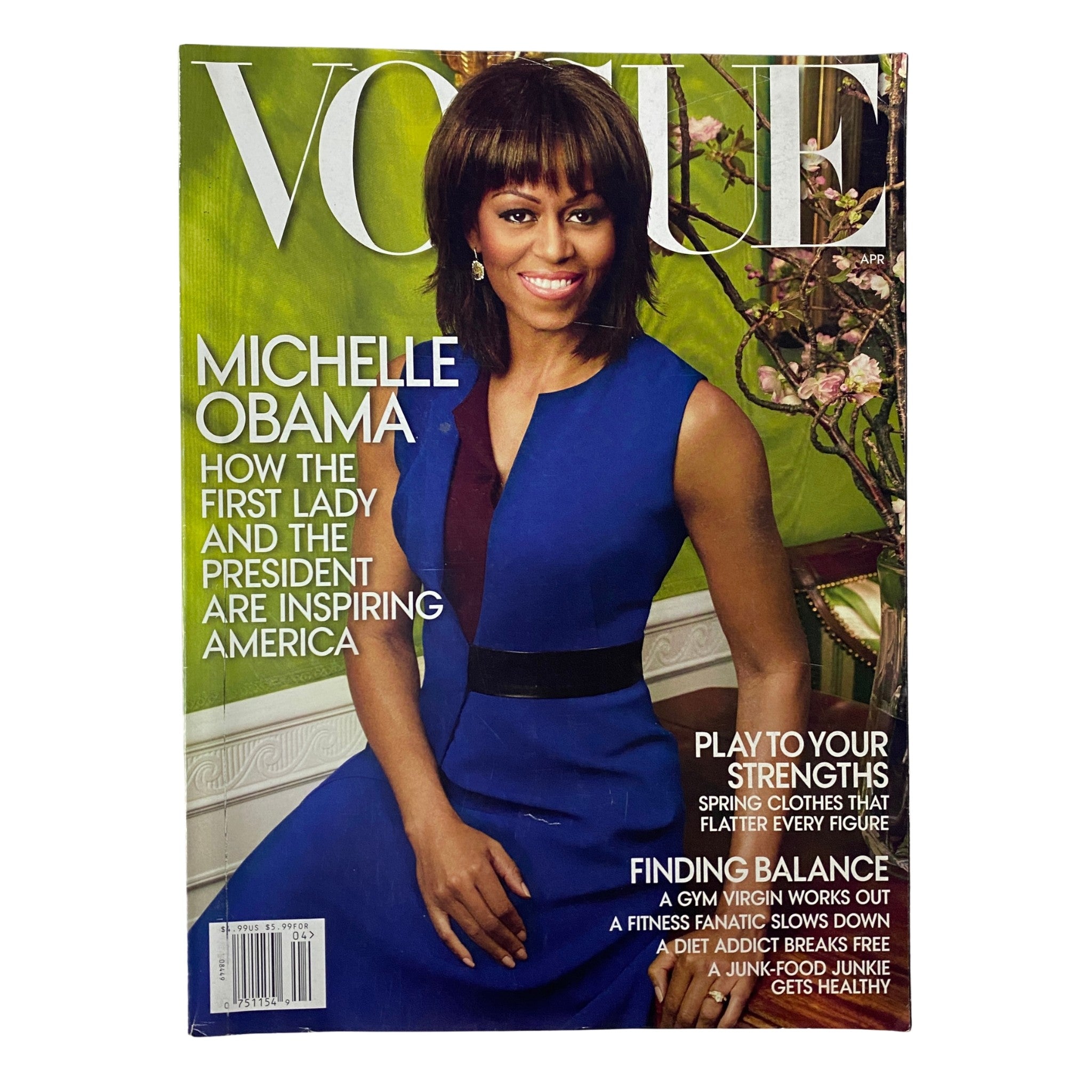 Cover of Vogue Magazine April 2013 featuring Michelle Obama, showcasing her in a stylish blue dress. The title, 'Vogue', is prominently displayed with text highlighting how the First Lady and the President are inspiring America.