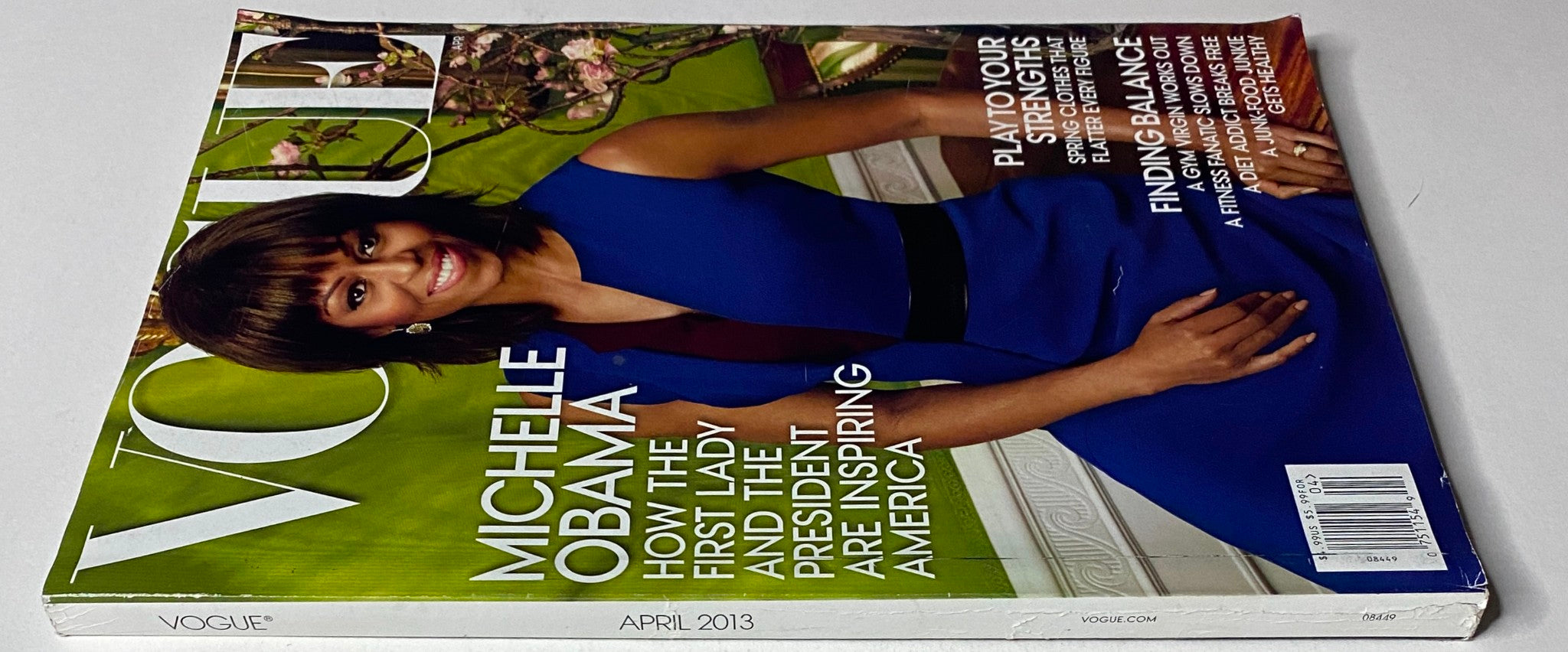 Side view of Vogue Magazine April 2013 featuring Michelle Obama on the cover. The magazine highlights various articles, including a feature on the impact of the First Lady and President on American culture.