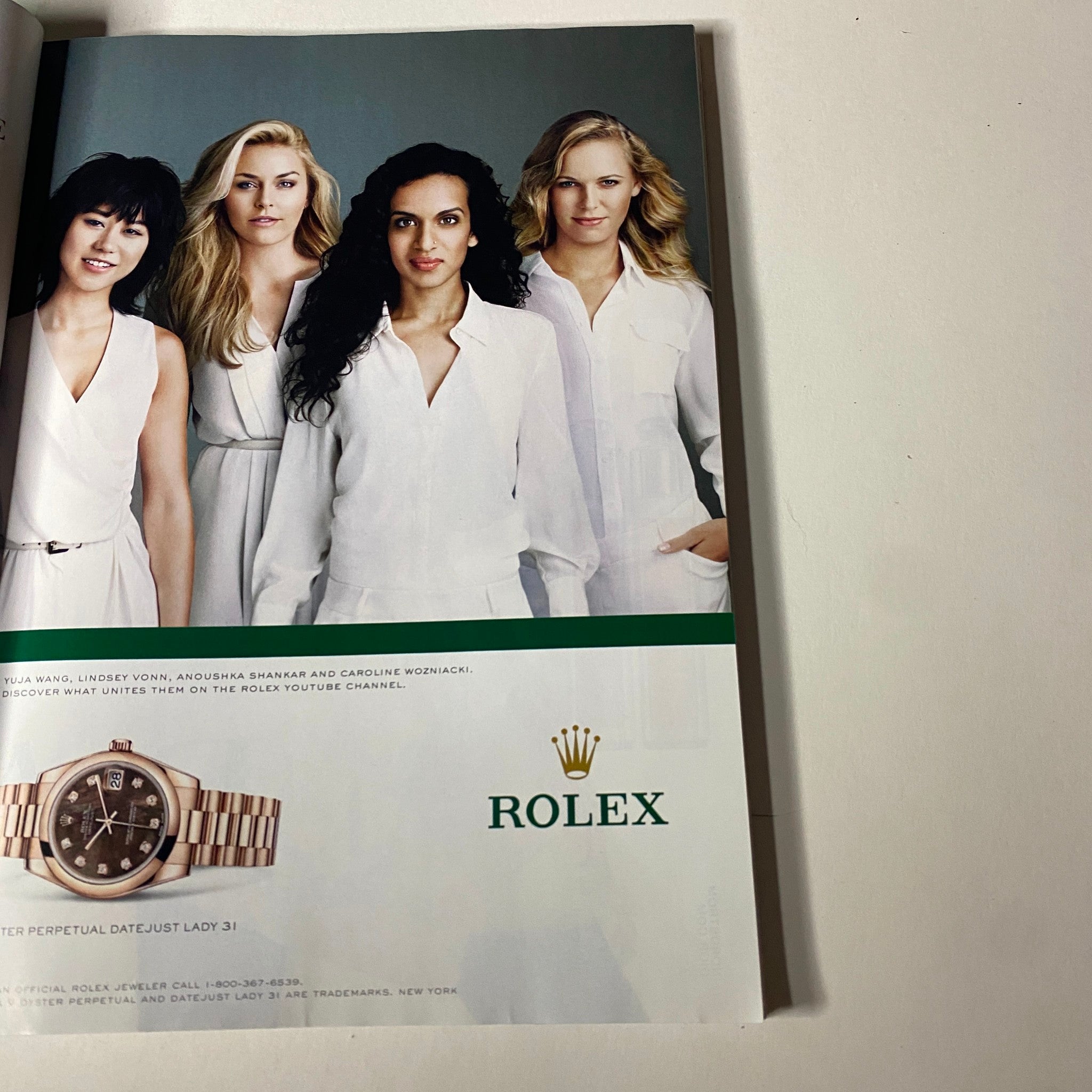 Vogue Magazine April 2013 Michelle Obama Cover No Label displaying a Rolex advertisement with four diverse models in white outfits, emphasizing luxury and style.