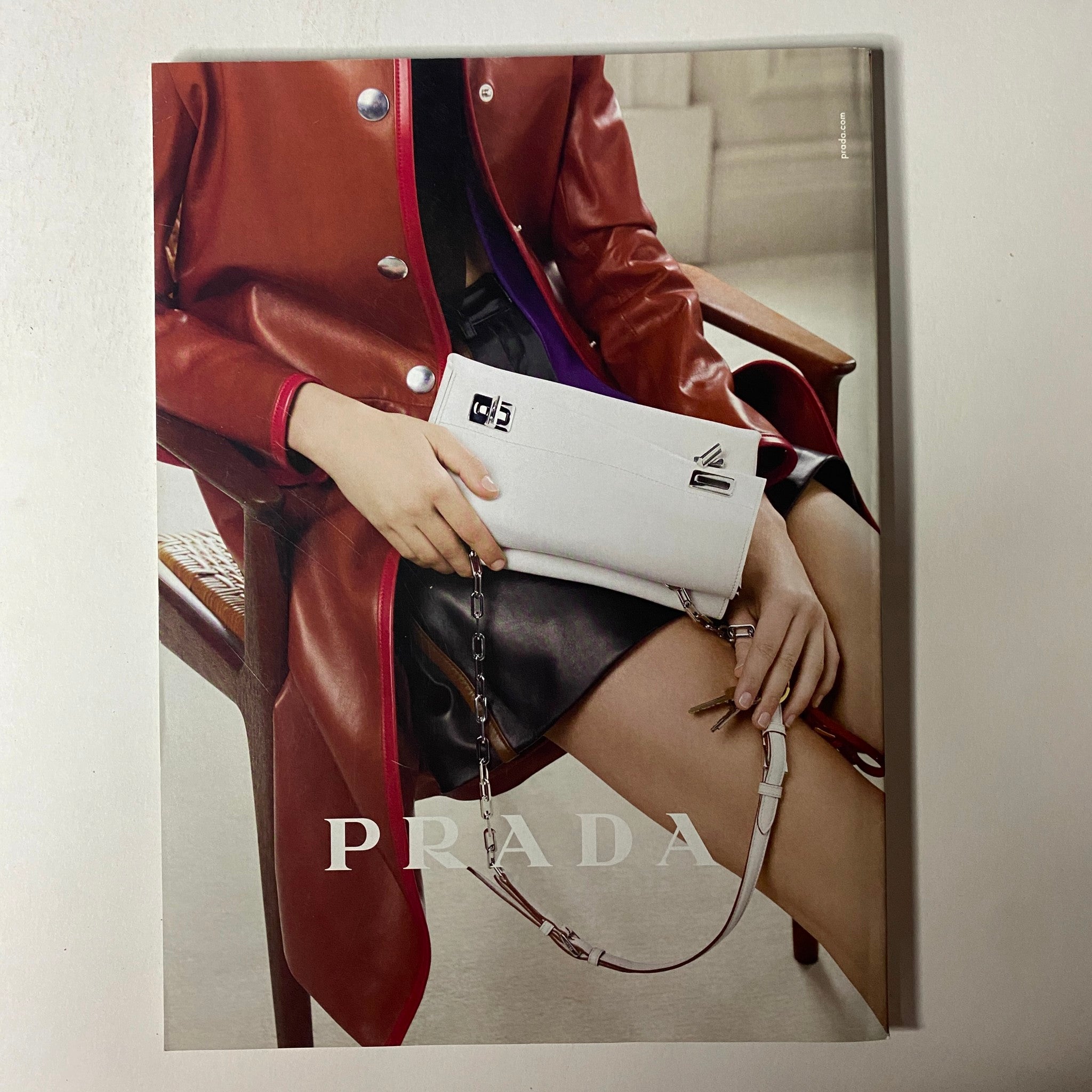Prada advertisement from Vogue Magazine June 2014, featuring a model with stylish accessories, embodying high fashion trends.