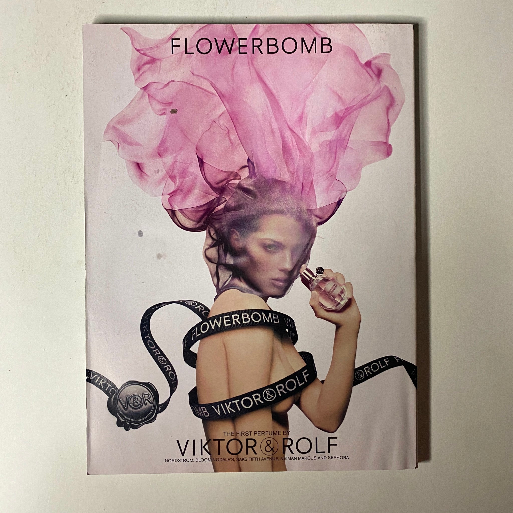 Vogue Magazine November 2014 Natalia Vodianova Cover includes an advertisement for Viktor & Rolf's Flowerbomb perfume, featuring a model with pink hair and a striking pose, encapsulating a sense of luxury and elegance.