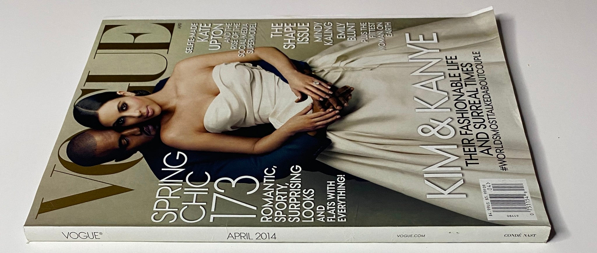 Side view of Vogue Magazine April 2014 with Kanye West and Kim Kardashian on the cover, showcasing the magazine in very good condition, titled 'Vogue Magazine April 2014 Kanye West & Kim Kardashian Cover No Label VG'.