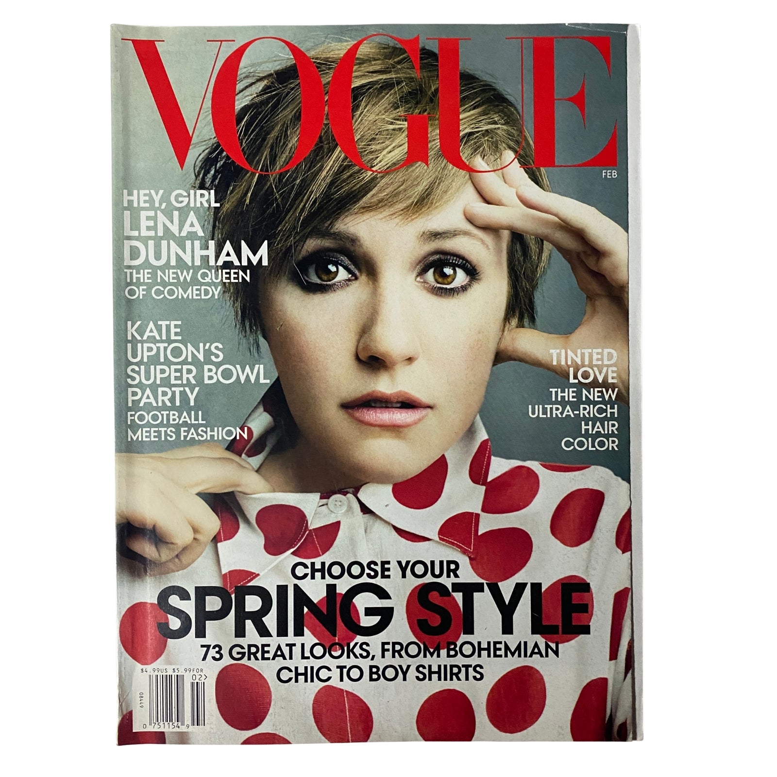 Vogue Magazine February 2014 featuring Lena Dunham on the cover, showcasing her playful fashion in a polka-dot shirt, with headlines about her as the new queen of comedy.
