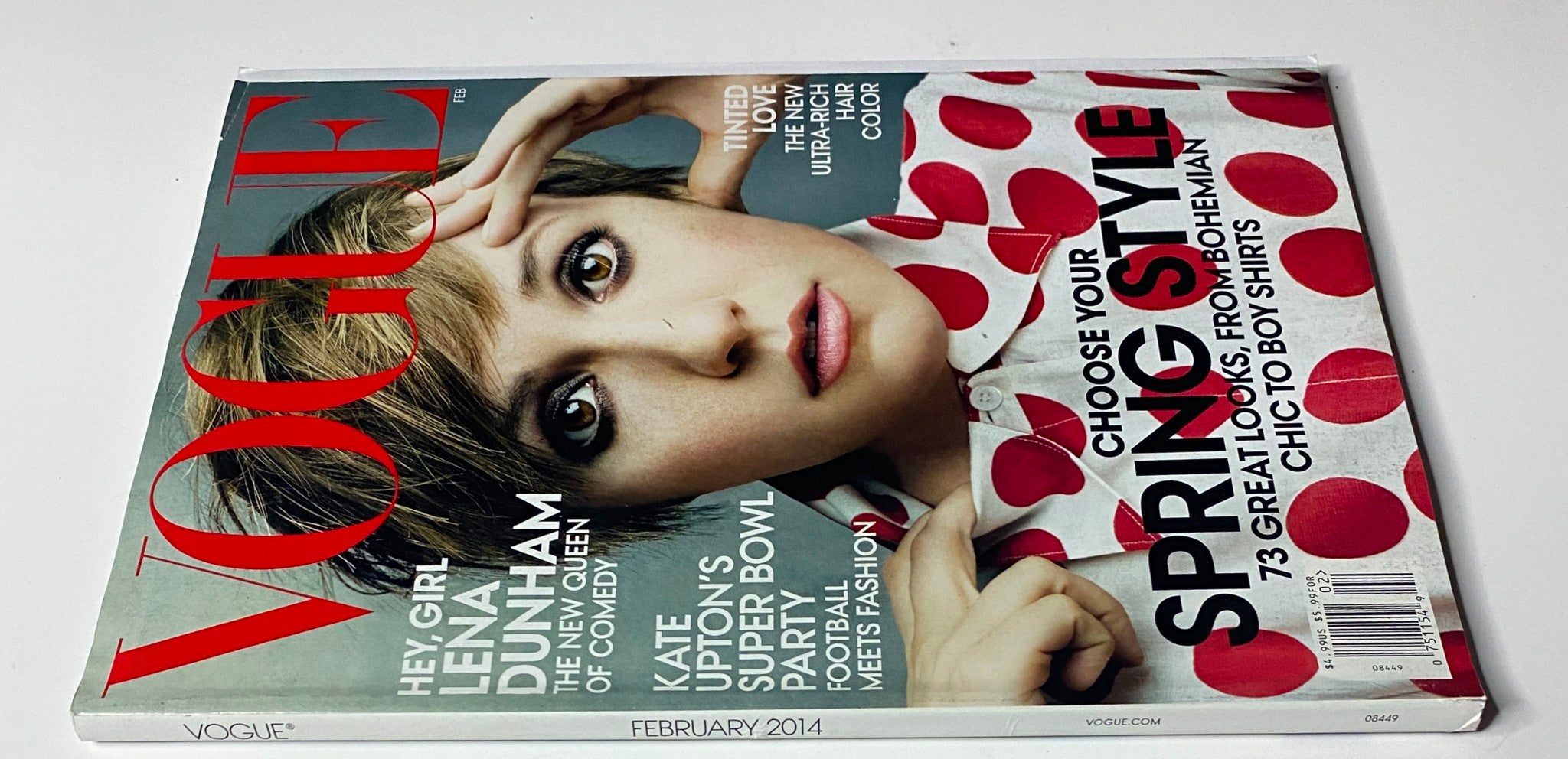 Vogue Magazine February 2014 edition with Lena Dunham's cover, emphasizing her role as a cultural figure and featuring stylish polka dot design.
