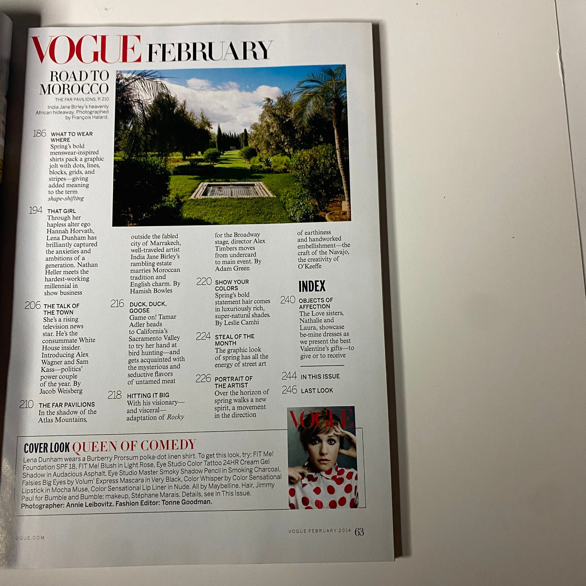 Vogue Magazine February 2014 features an article titled 'Road to Morocco' showcasing a lush garden landscape. This page includes high-fashion content related to travel and style.