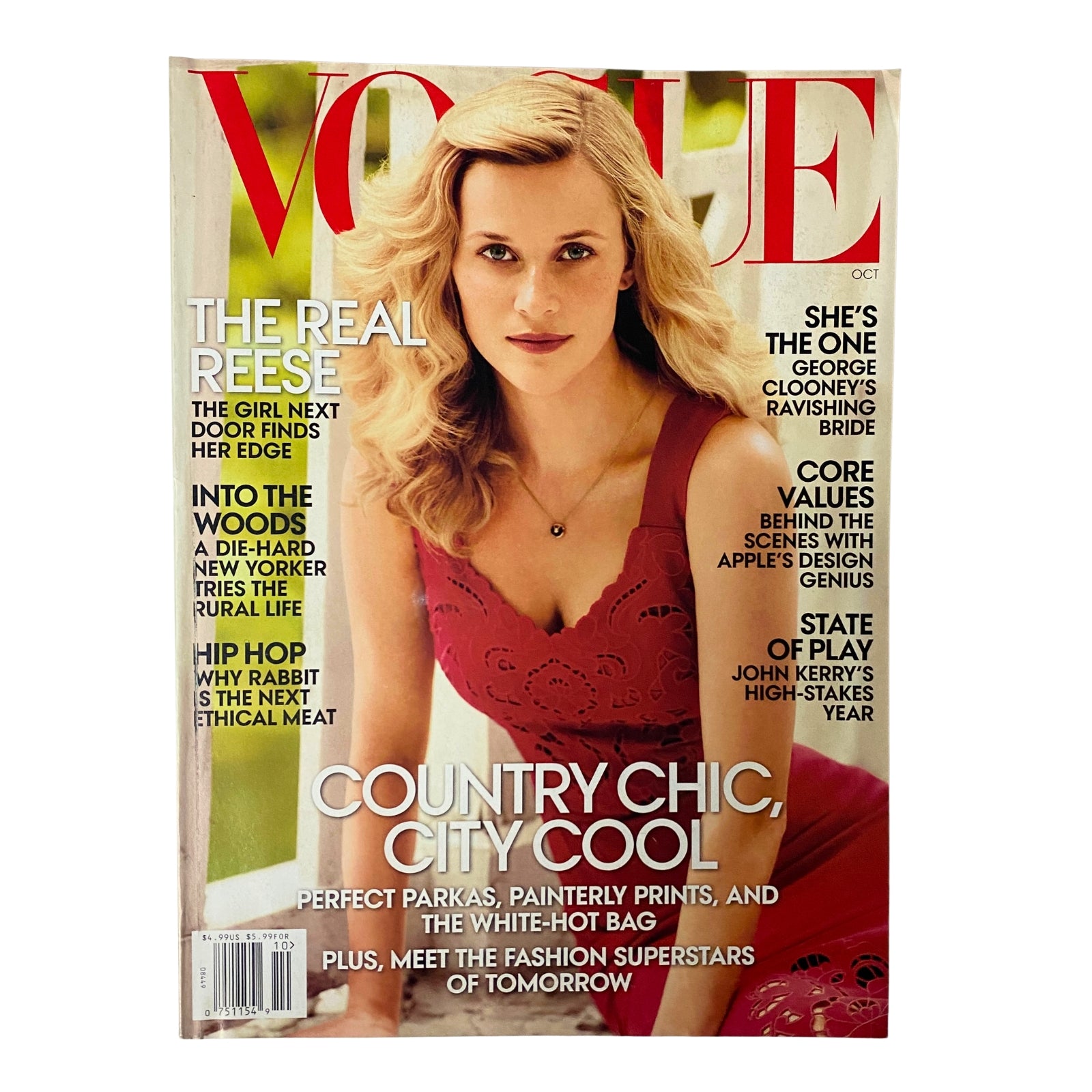 Vogue Magazine October 2014 cover featuring Reese Witherspoon in a red dress, highlighting her style and beauty. The cover includes headlines about fashion and celebrity lifestyle.