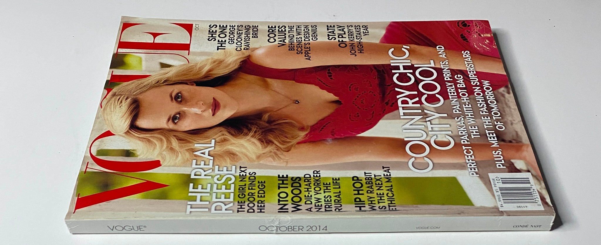 Side view of Vogue Magazine October 2014 with Reese Witherspoon on the cover. The magazine emphasizes 'Country Chic, City Cool' and includes features about modern fashion and influential women.
