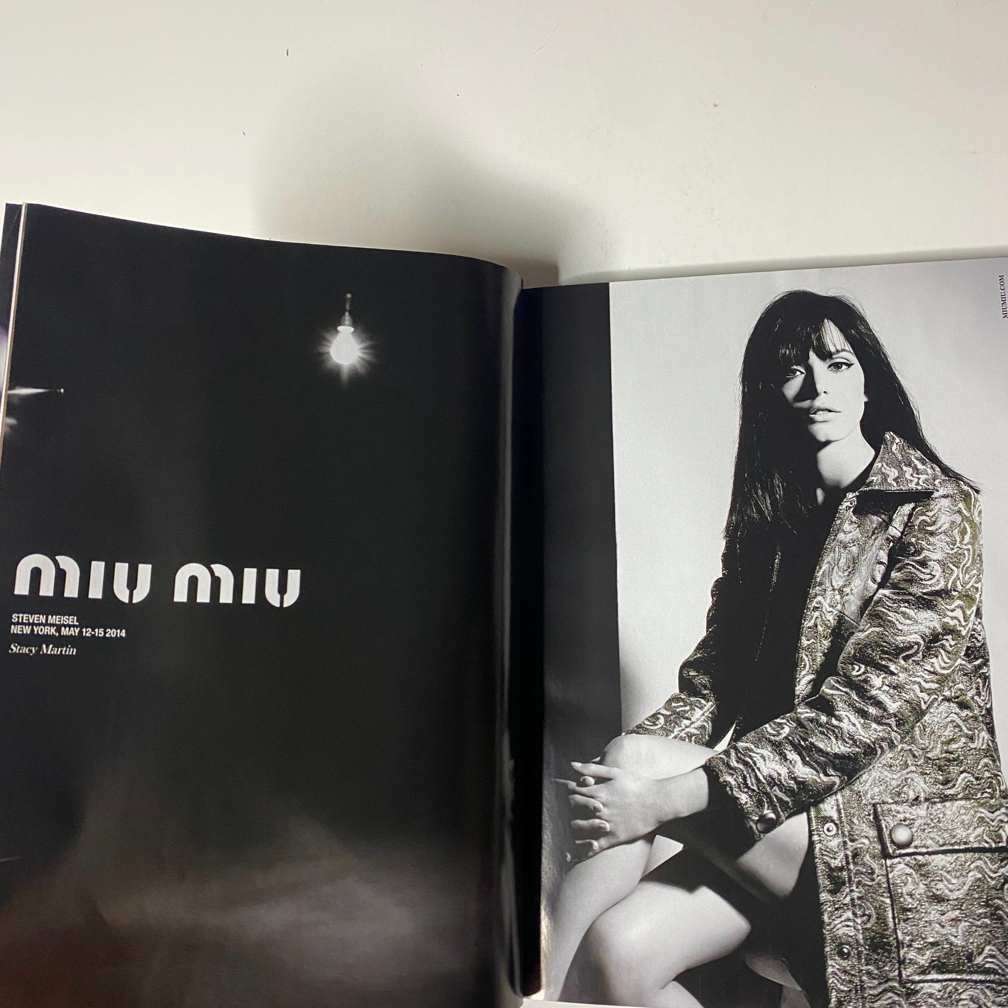Vogue Magazine October 2014 showcasing a Miu Miu fashion spread with a model in black and white photography.