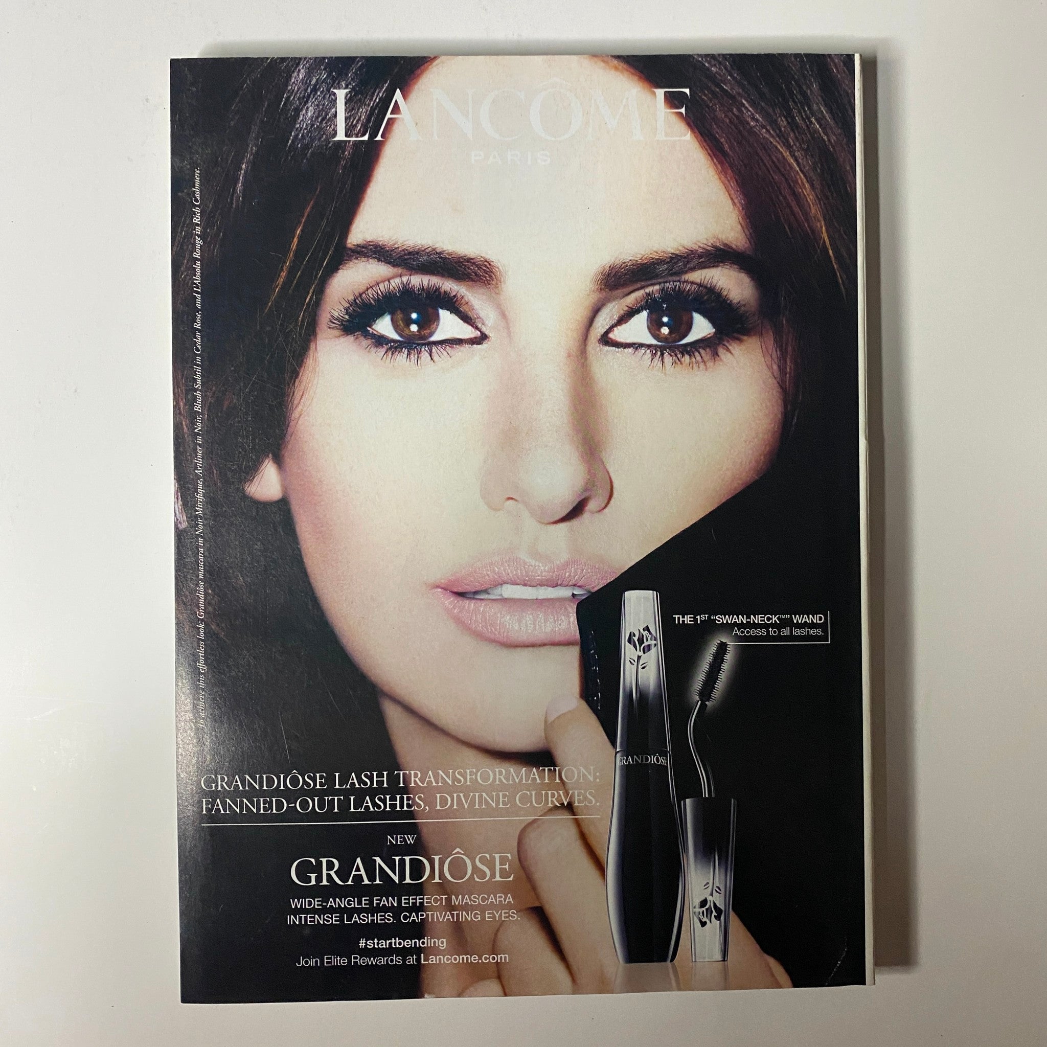 Vogue Magazine October 2014 advertisement for Lancome's Grandiôse mascara featuring close-up of a model's dramatic eye makeup.