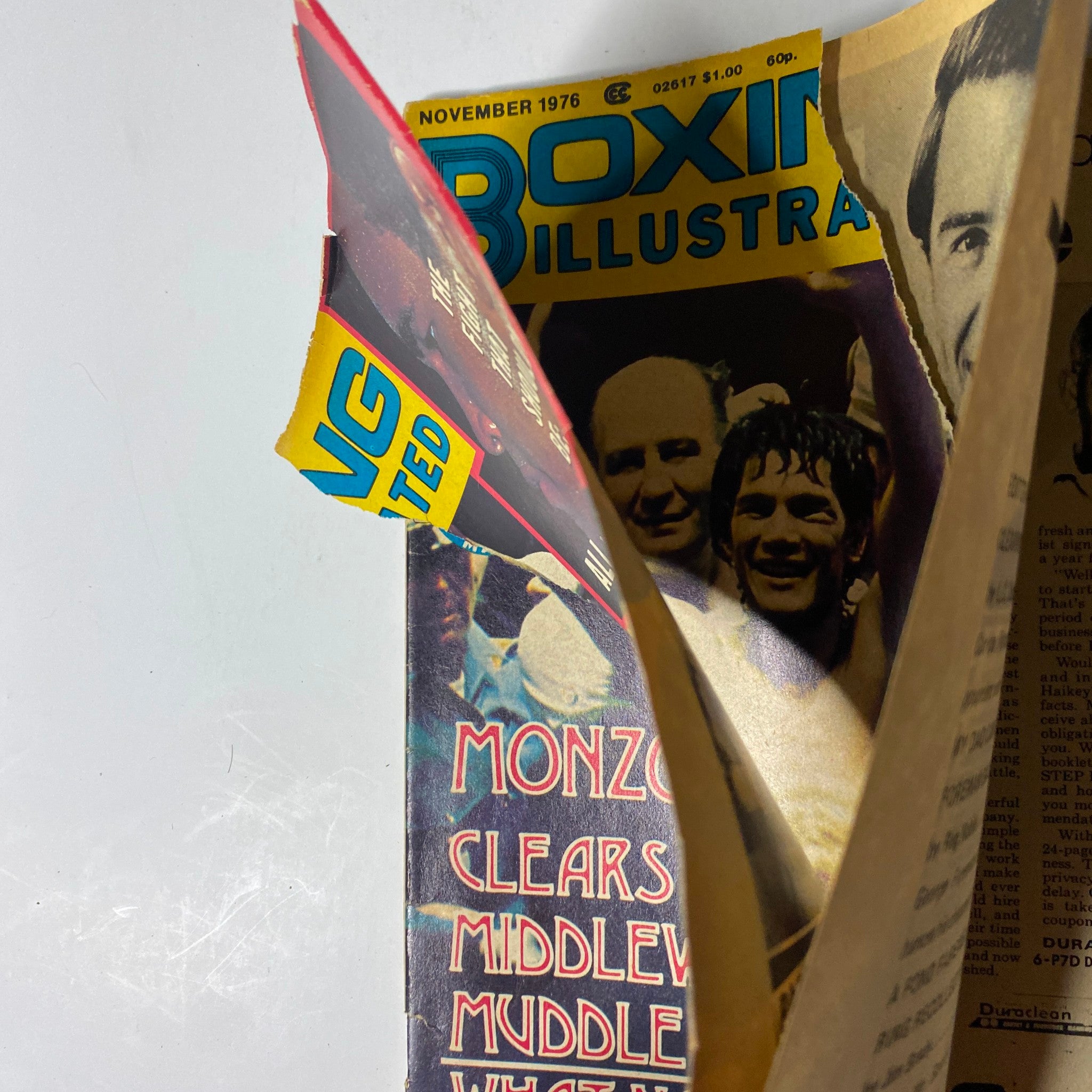 Side view of the cover of Boxing Illustrated Magazine November 1976 revealing a glimpse of fighters and the headline 'MONZON CLEARS MIDDLEWEIGHT MUDDLE'.