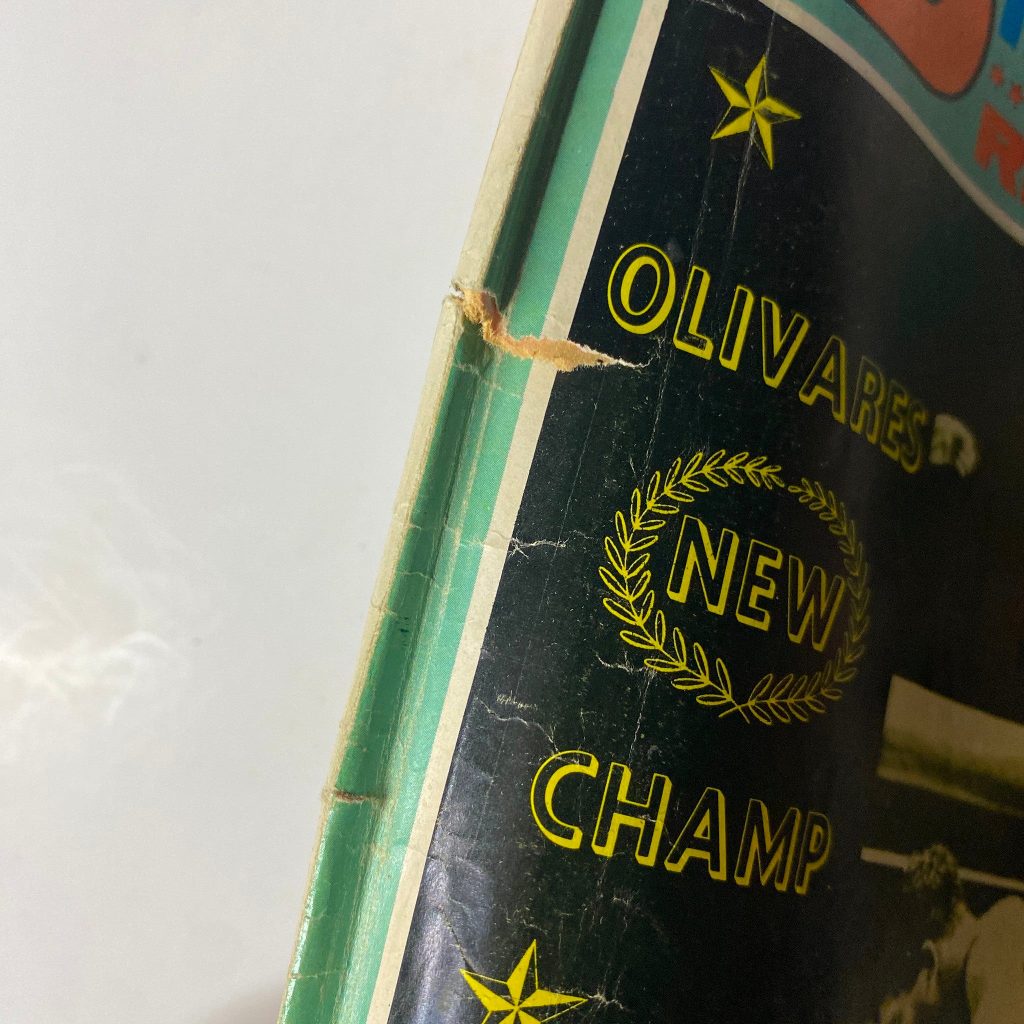 Close-up of the edge of Boxing Illustrated Magazine November 1969 featuring Rubén Olivares, showing creased cover and text 'OLIVARES NEW CHAMP'.
