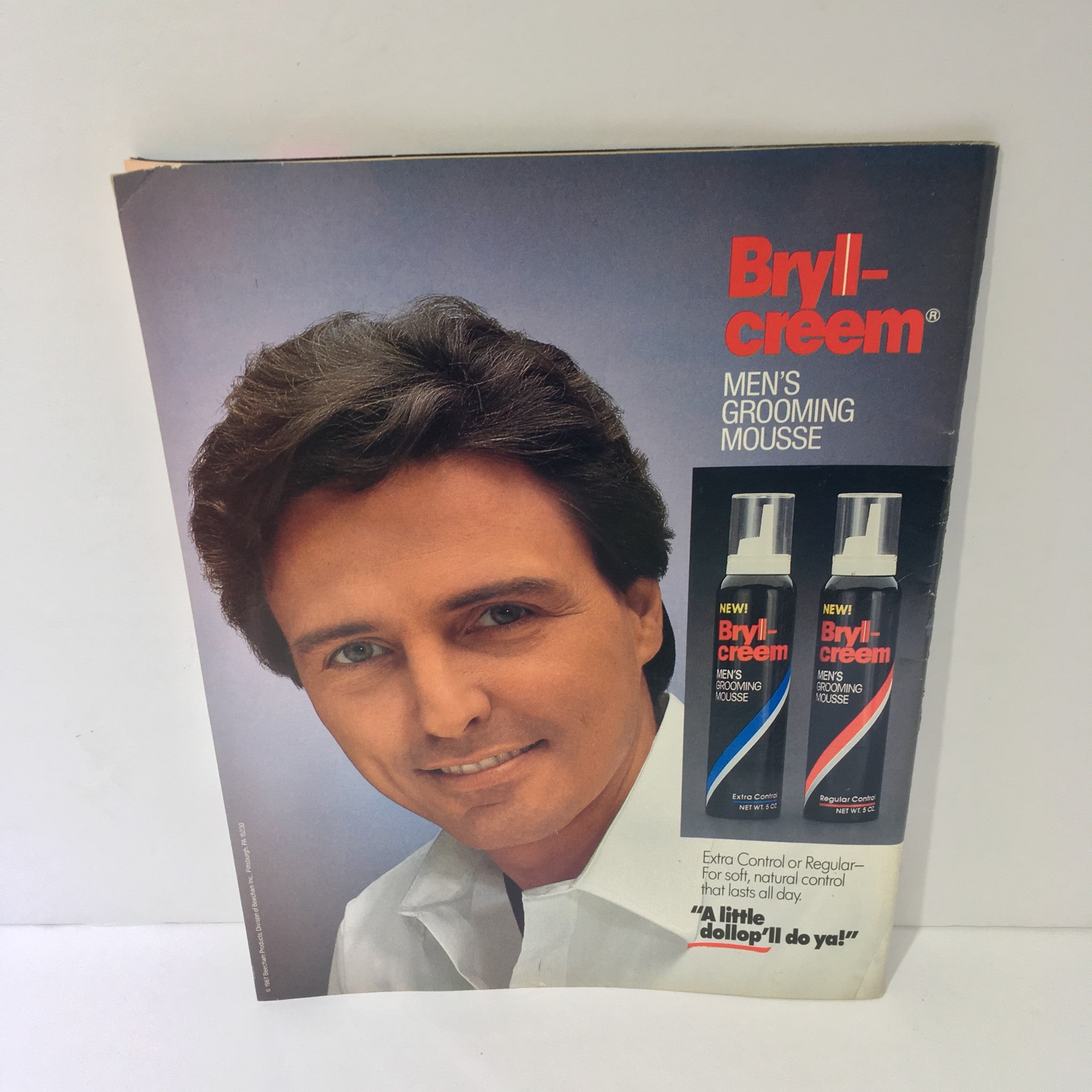 Promotional page for Bryll-creem Men's Grooming Mousse, featuring a male model with styled hair, from the May 1988 WWF Magazine.
