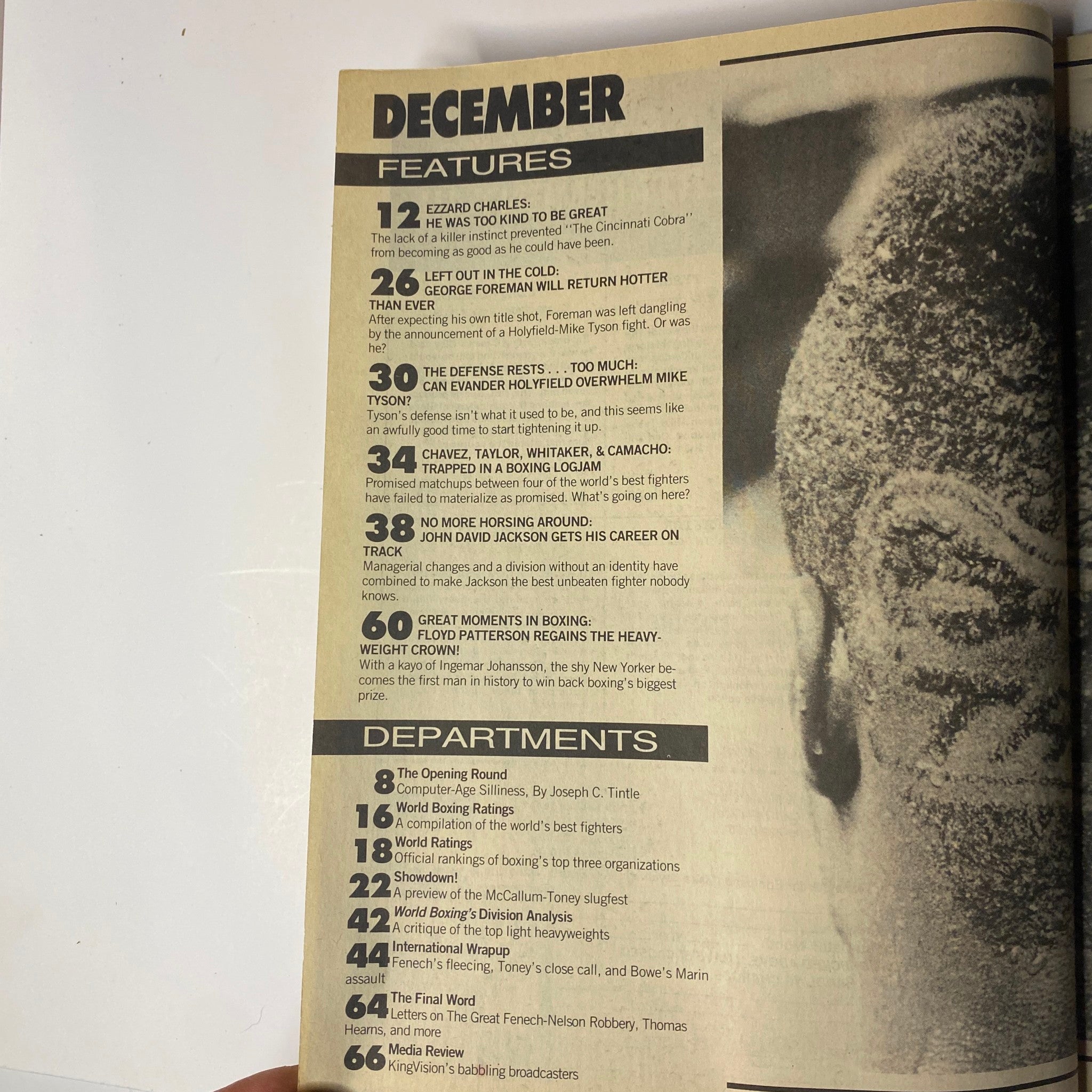 Inside page of World Boxing Magazine December 1991 listing features and departments, including articles on Ezzard Charles, George Foreman, and other boxing legends.