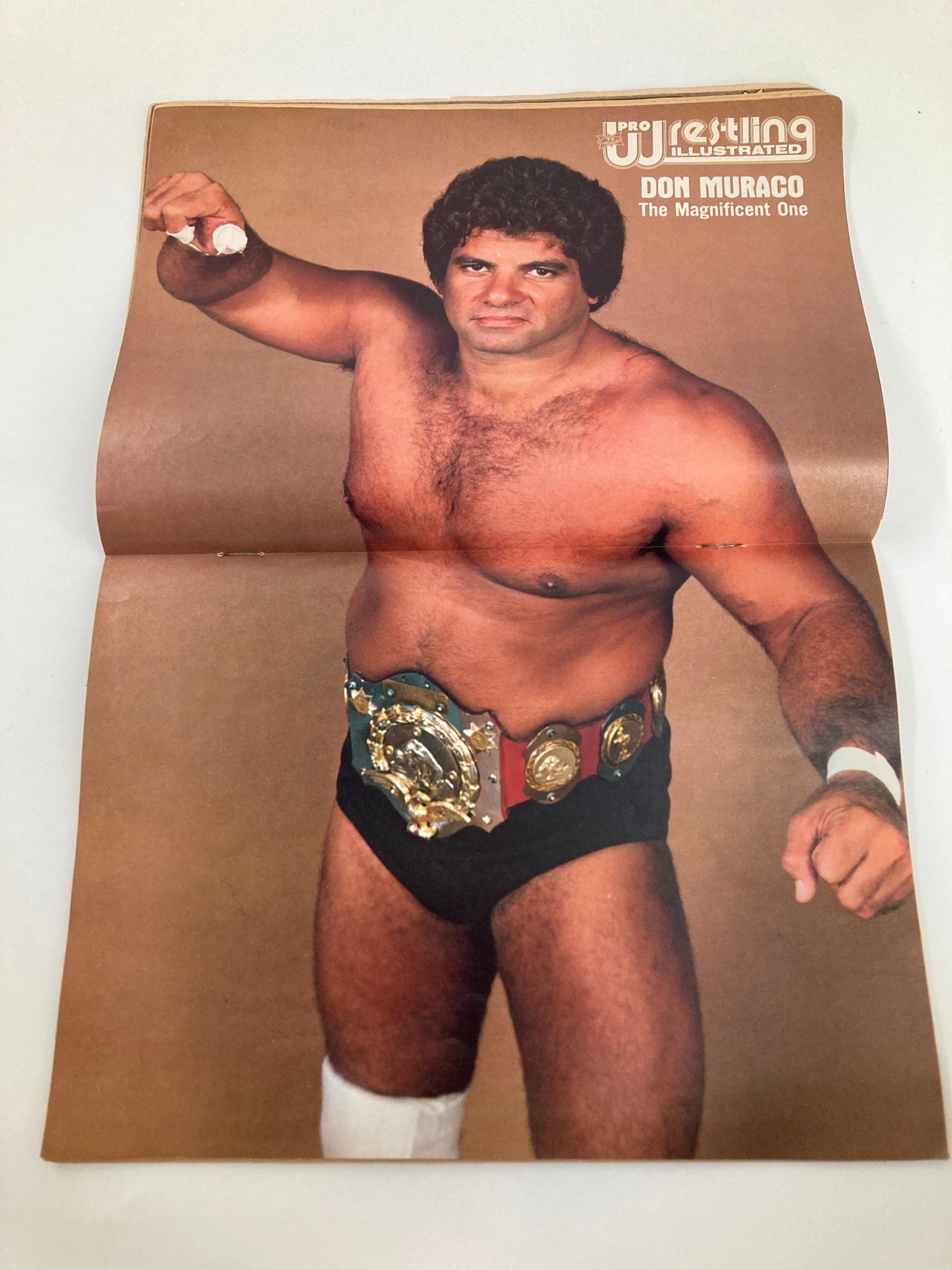 Centerfold of Pro Wrestling Illustrated Magazine January 1982 showcasing Don Muraco, the Magnificent One, wearing a championship belt and posing for the magazine.