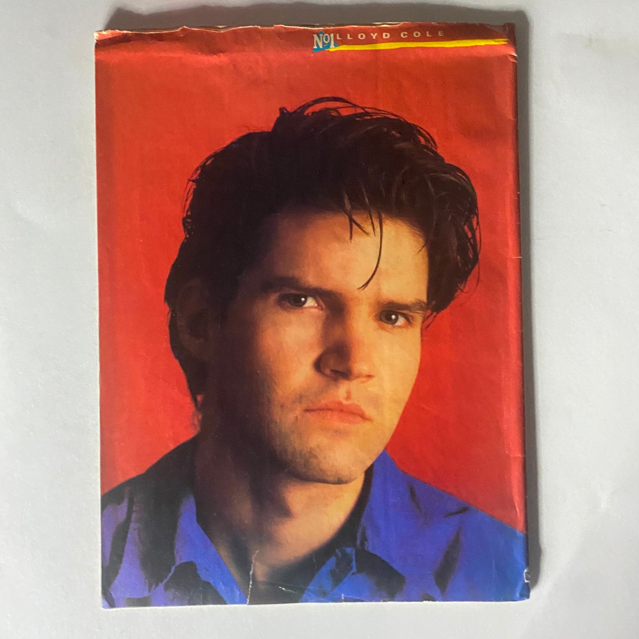 Cover of the VTG No. 1 Magazine November 30, 1985 featuring a portrait of Lloyd Cole against a striking red background.