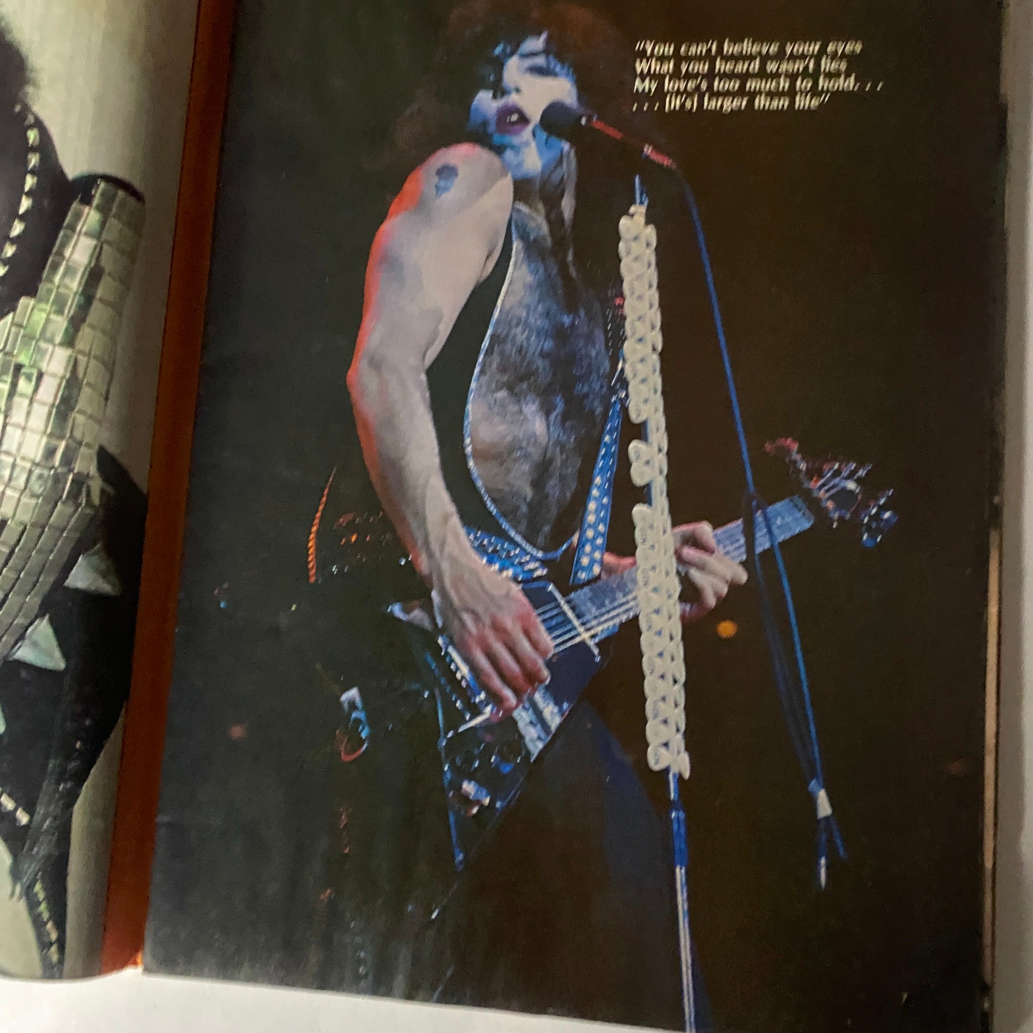 Photograph of a Kiss band member performing, taken from the New Wave Rock Presents Supergroups magazine, with quoted lyrics included.