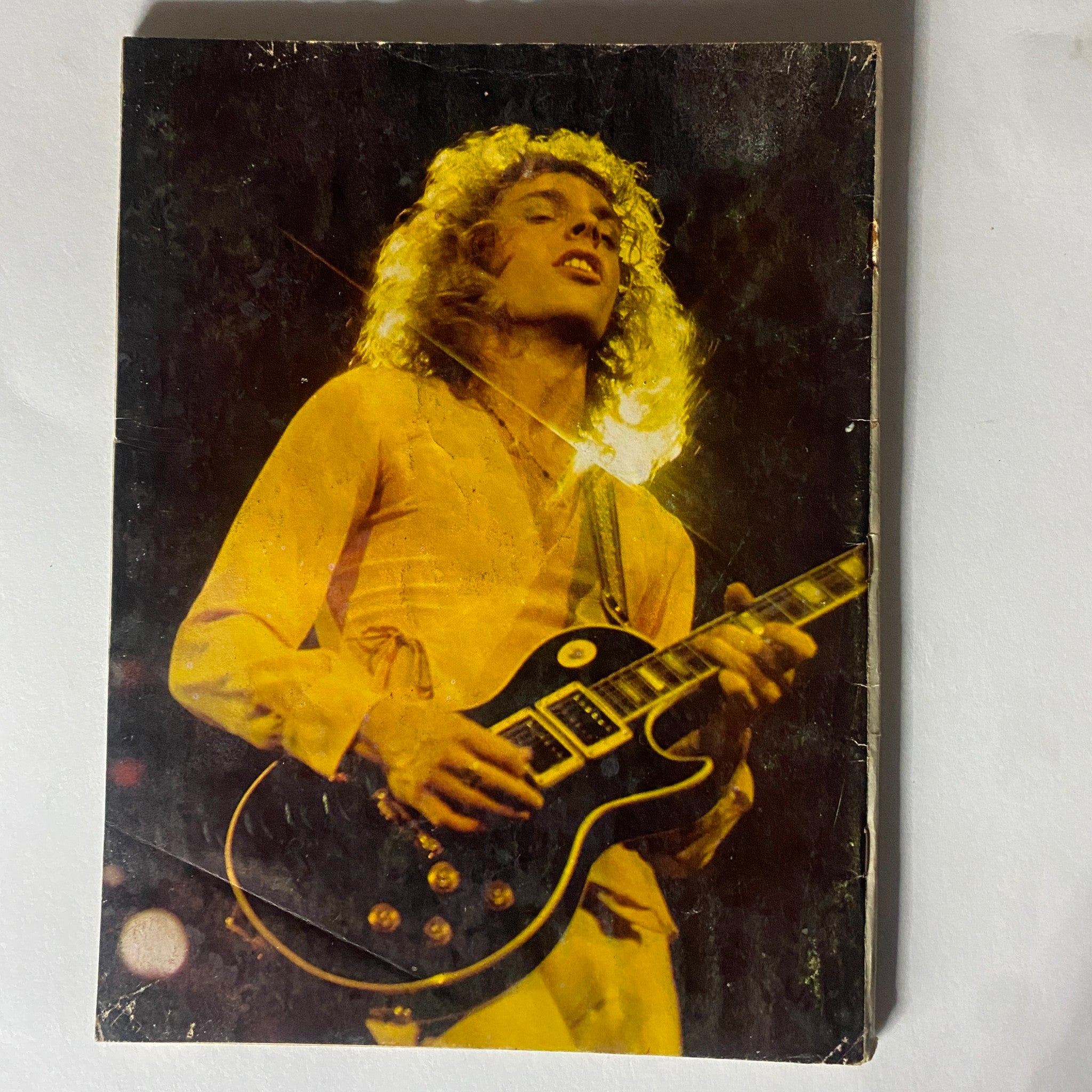 Rock musician performing live with an electric guitar, captured in a vintage photograph for 'New Wave Rock Presents Supergroups' November 1978, highlighting the era's music culture.