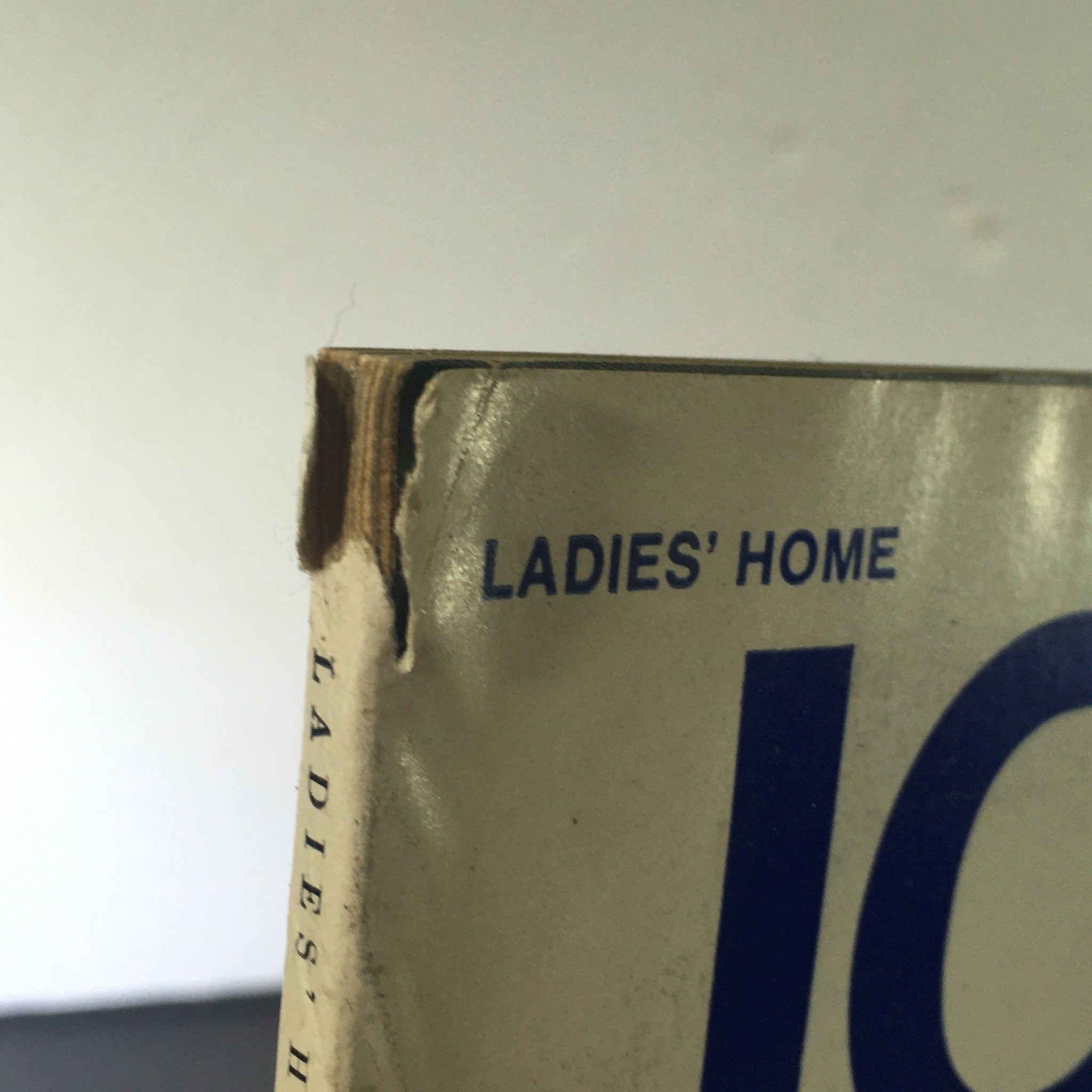 Close-up view of the top corner of the March 1972 Journal Magazine, featuring a visible tear and the title 'LADIES' HOME' on the cover.