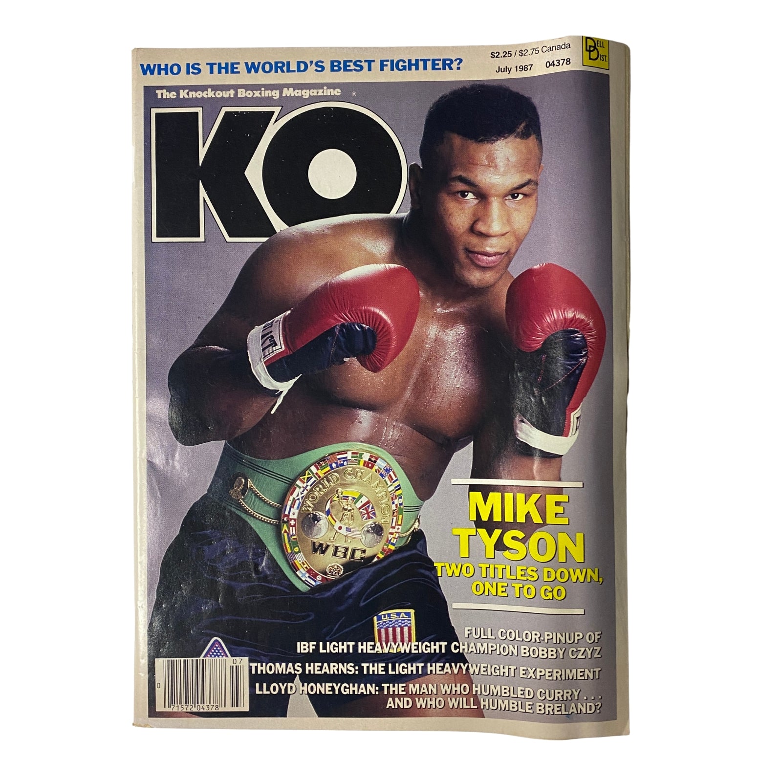 KO Boxing Magazine July 1987 featuring Mike Tyson on the cover, showcasing him with the WBC championship belt. The cover highlights Tyson's rising dominance in boxing, labeled 'Mike Tyson: Two Titles Down, One to Go'.