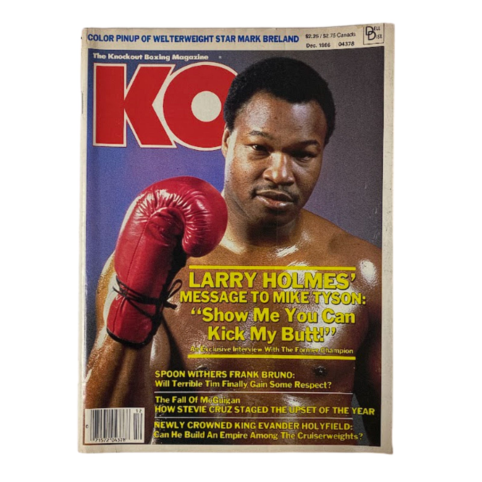 Cover of KO Boxing Magazine December 1986 featuring Larry Holmes with a red boxing glove, highlighting his message to Mike Tyson: 'Show Me You Can Kick My Butt!'. Good condition, no label.