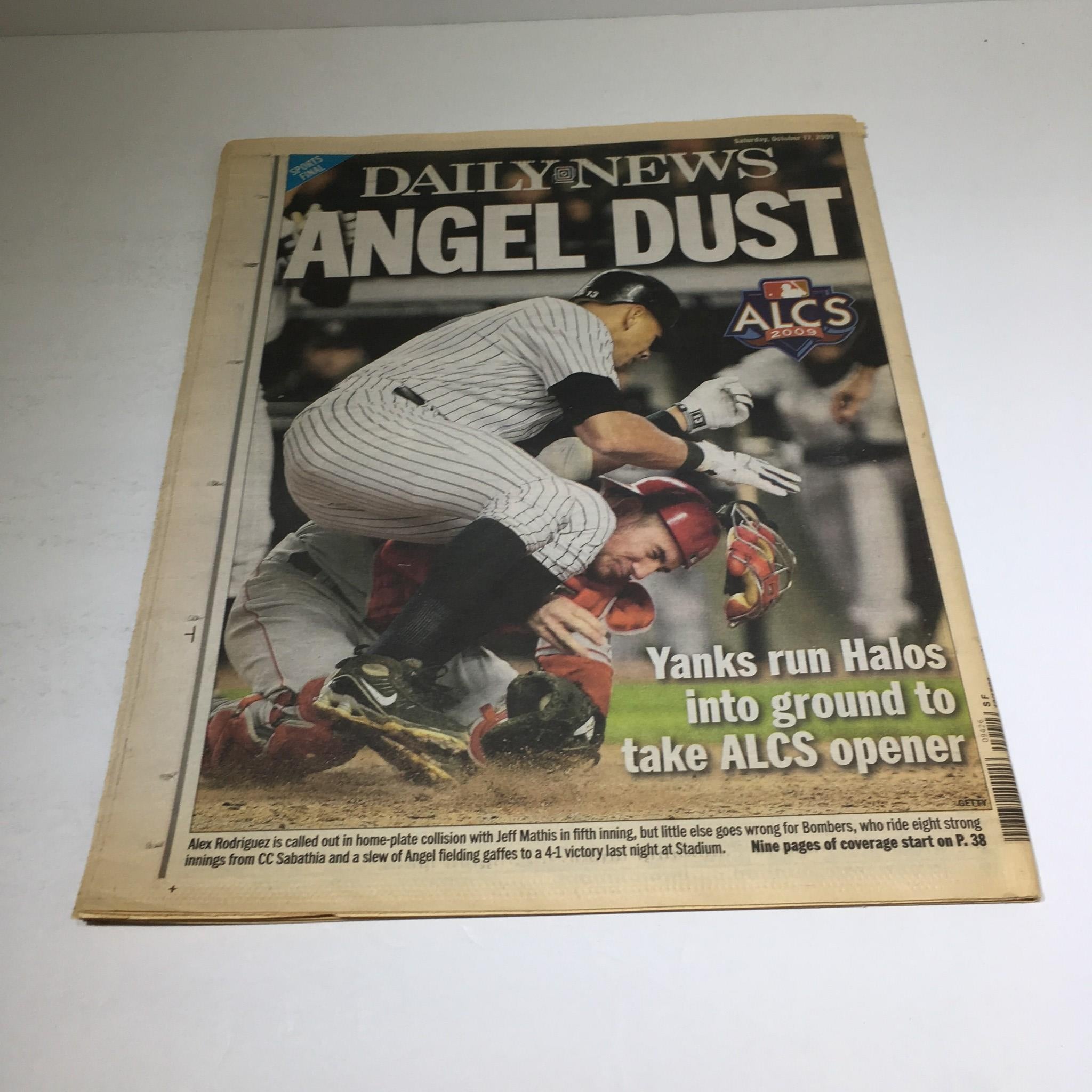 NY Daily News cover titled 'ANGEL DUST' from October 17, 2009, depicting a collision between Yankees and Angels players during the ALCS opener.