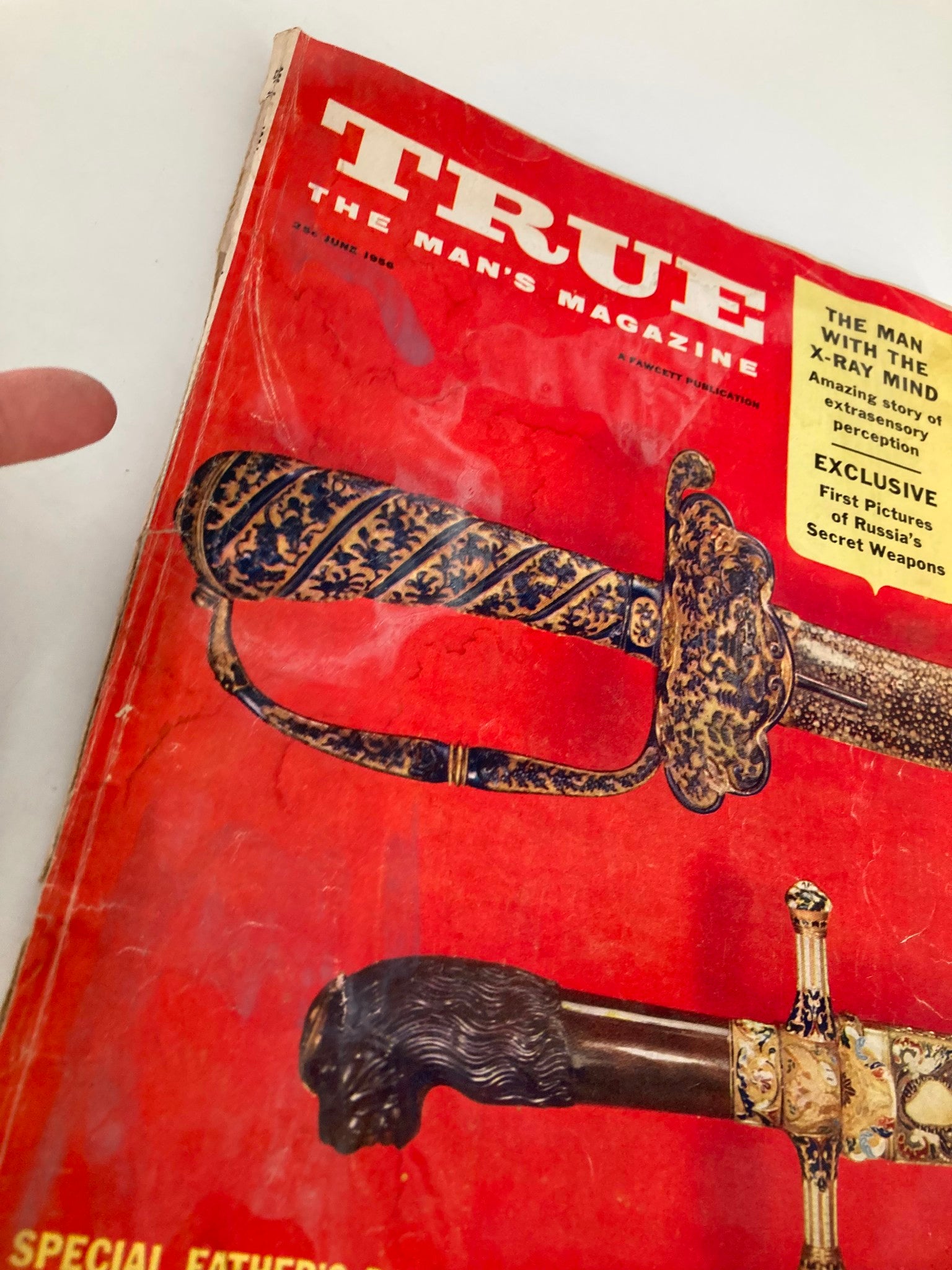 Close-up view of the cover of TRUE The Man's Magazine June 1956, emphasizing the title 'The Man with the X-Ray Mind' and the intricate designs of swords along with the promotional text regarding exclusive content.