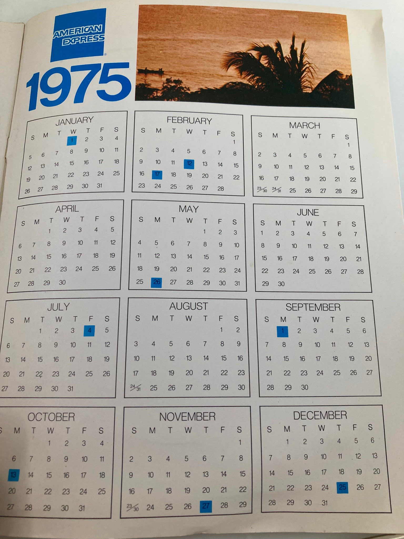 Monthly calendar for 1975 featured in The Caribbean Book 1975 by American Express, illustrating travel dates and events for the year.