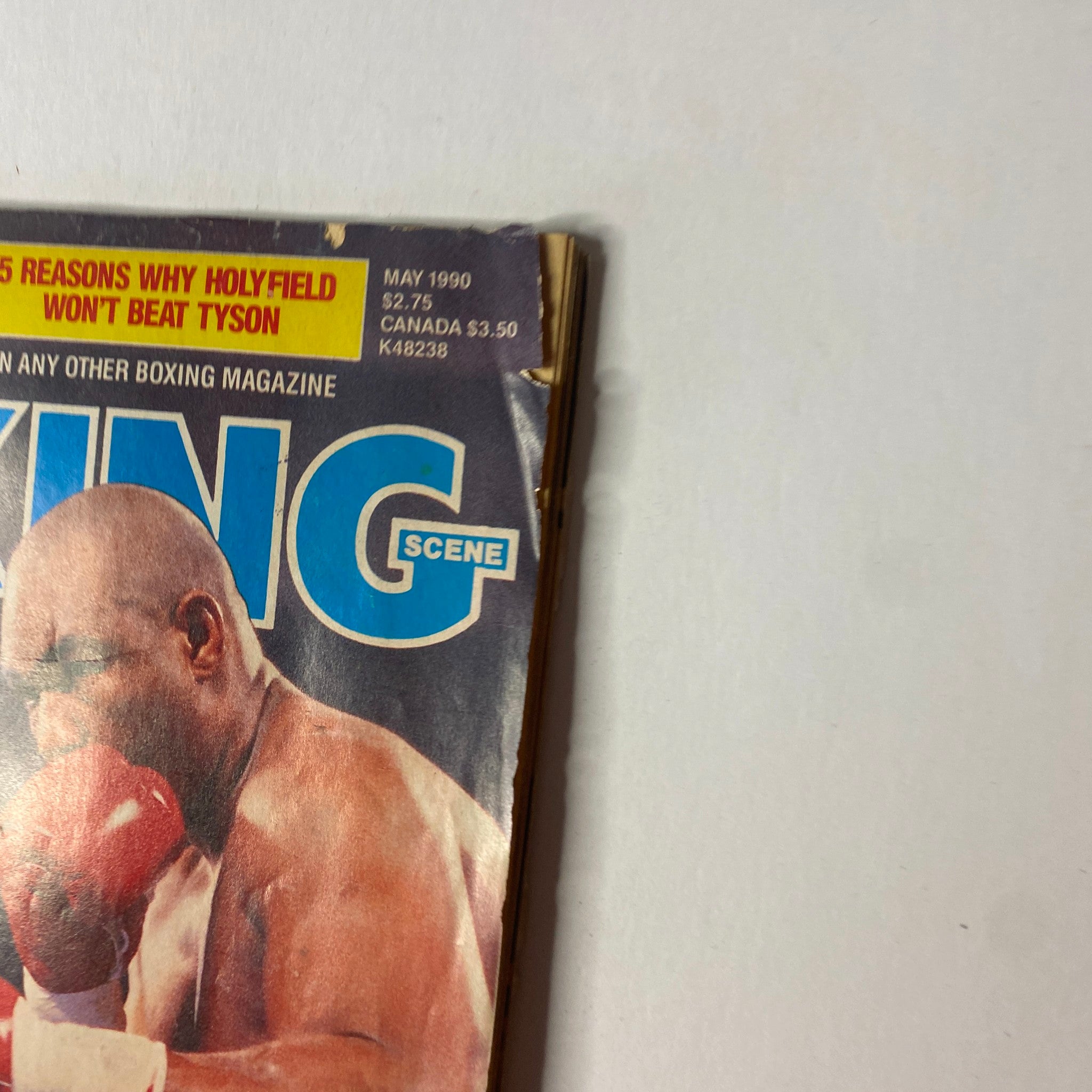 Cover of Boxing Scene Magazine May 1990 featuring George Foreman and Mike Tyson, showcasing their iconic rivalry in the boxing world.
