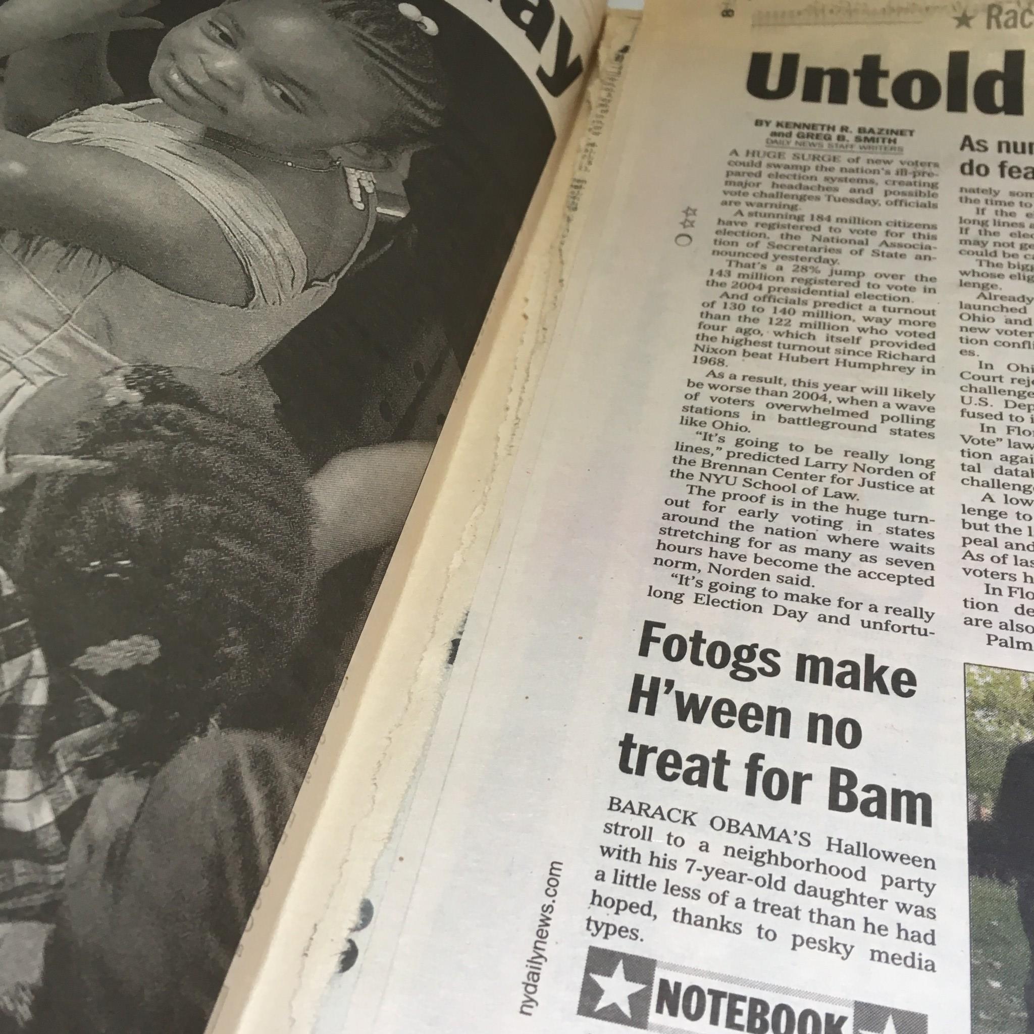 Close-up of the NY Daily News from Nov 10, 2008, featuring an article about a neighborhood Halloween party attended by Barack Obama. The page shows a child with a joyful expression.