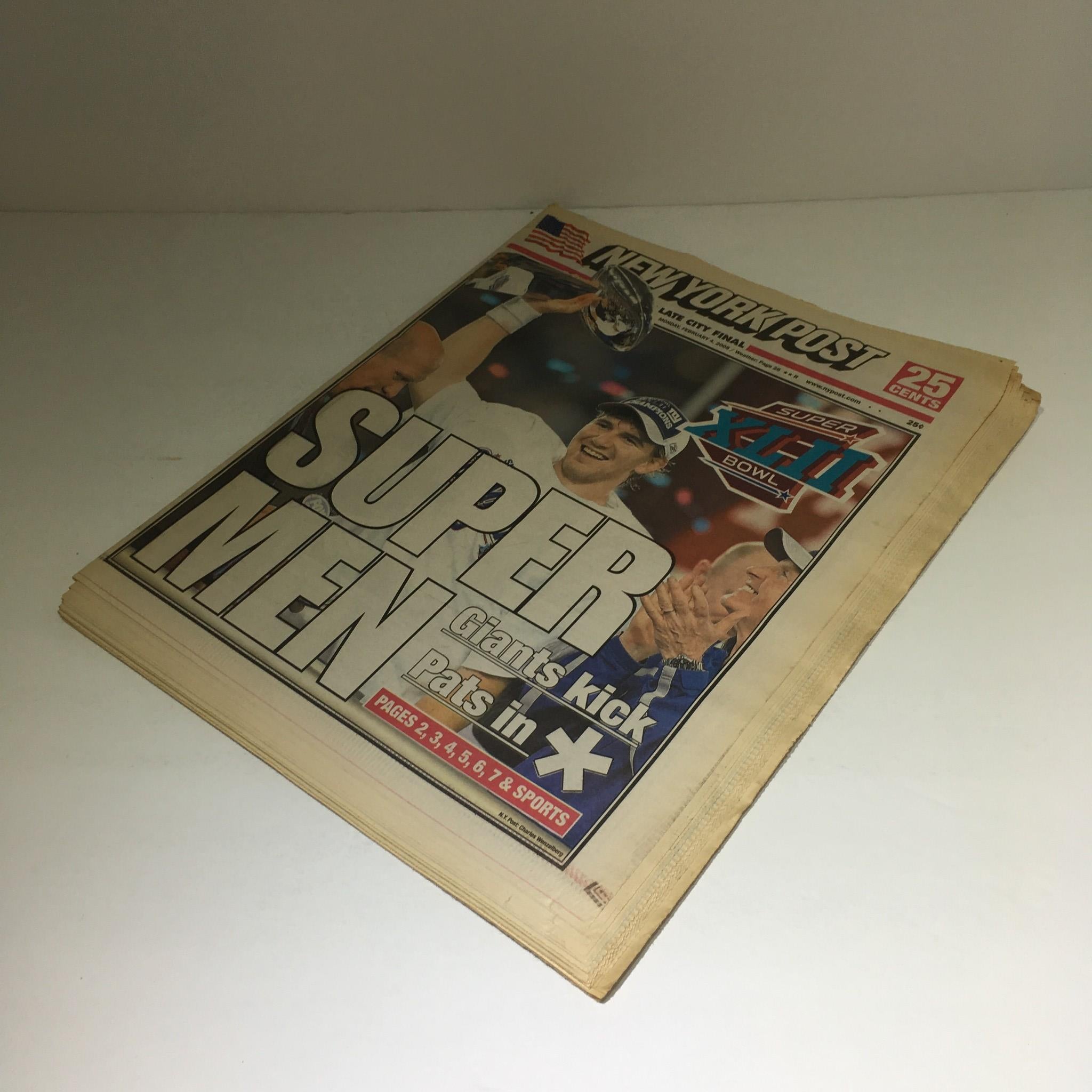New York Post: Feb 4 2008 Super Men Giants Kick Pats in - Front page showcasing jubilant Giants player holding the championship trophy with bold headline 'SUPER MEN'.