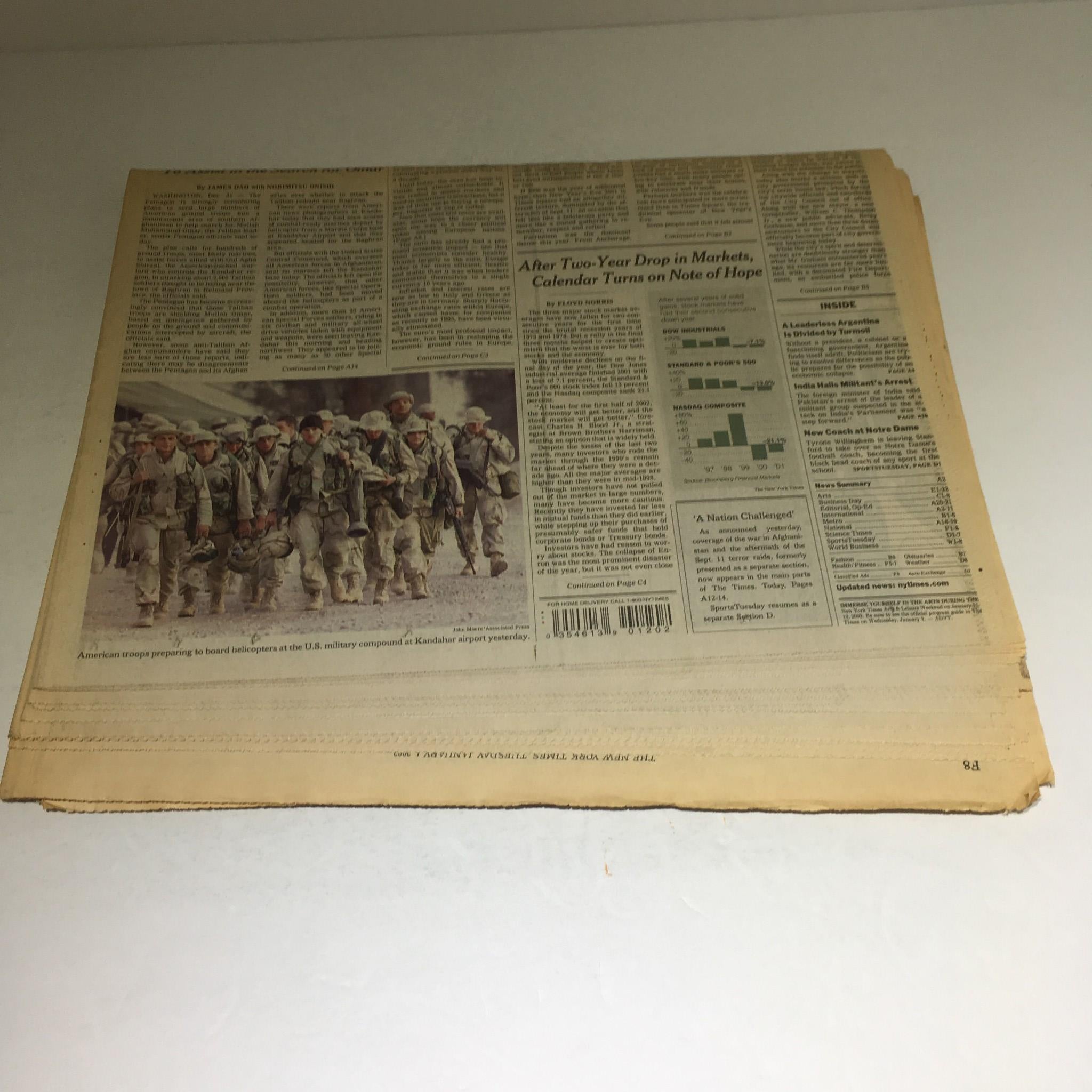 Reverse side view of The New York Times from January 1, 2002, showing articles and advertisements.