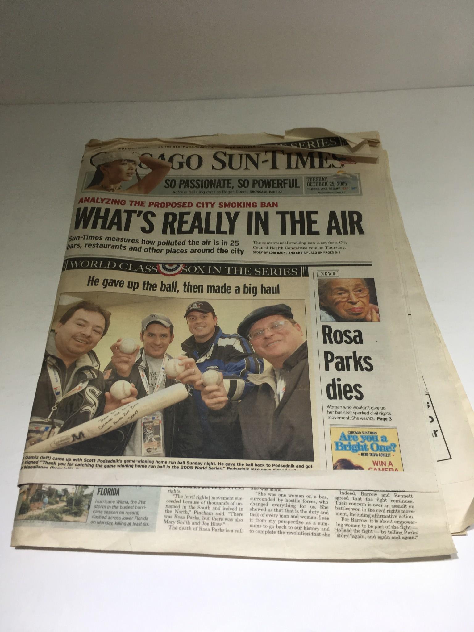 Chicago Sun-Times: October 25, 2005 edition featuring the headline 'What's Really in the Air' and a group of individuals celebrating a major event, showcasing the essence of news from that time.