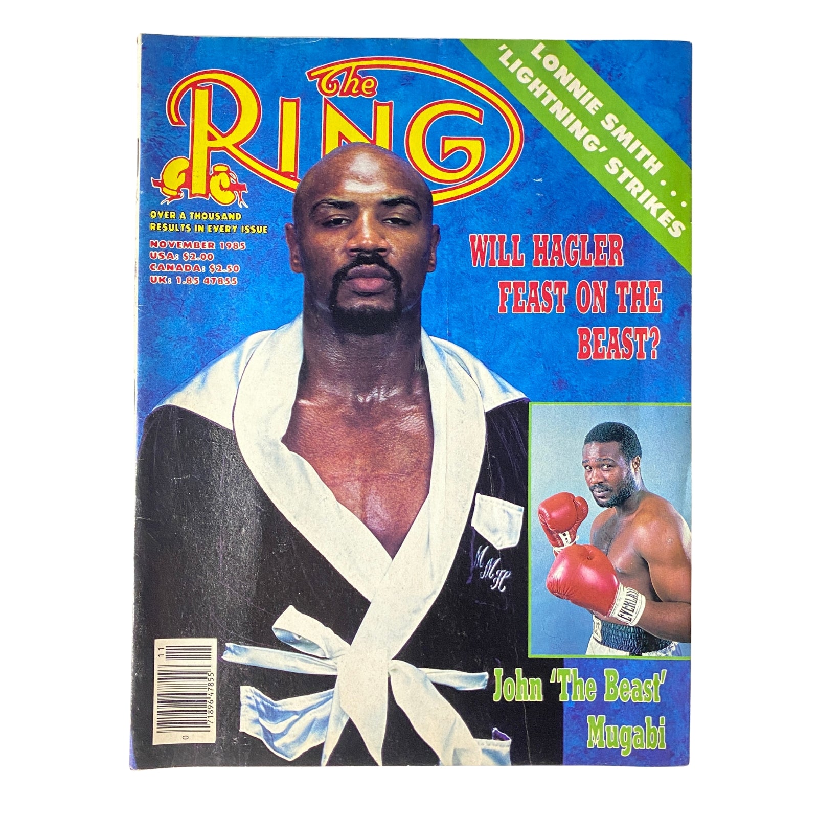 The Ring Magazine cover from November 1985 featuring John Mugabi in a boxing robe with the title 'Will Hagler Feast on The Beast?' This issue highlights the matchup between Marvin Hagler and John Mugabi, adding historical context to boxing in the 1980s.
