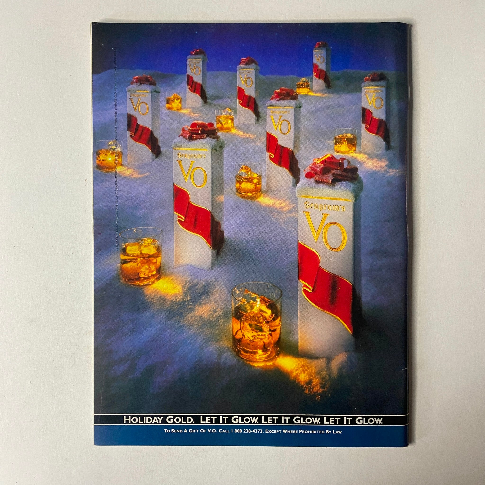Advertisement page in Sports Illustrated Magazine December 11, 1989, showcasing Seagram's VO whiskey with the slogan 'Holiday Gold. Let it Glow.'