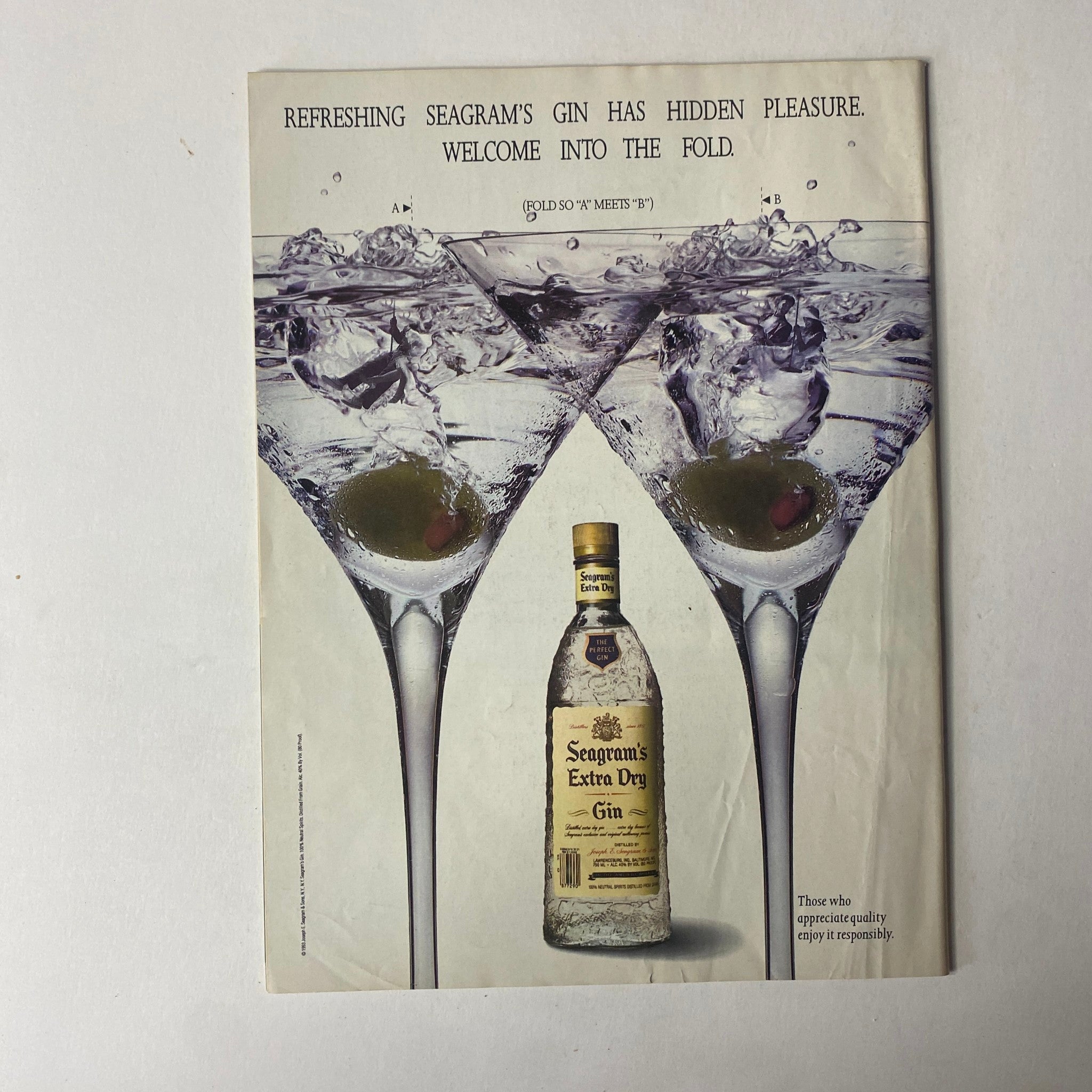 Vintage advertisement featuring Seagram's Extra Dry Gin with two elegant martini glasses filled with ice and olives. The ad promotes a refreshing experience with the slogan 'Refreshing Seagram's Gin has hidden pleasure. Welcome into the fold.' Perfect for collectors of vintage spirits ads.