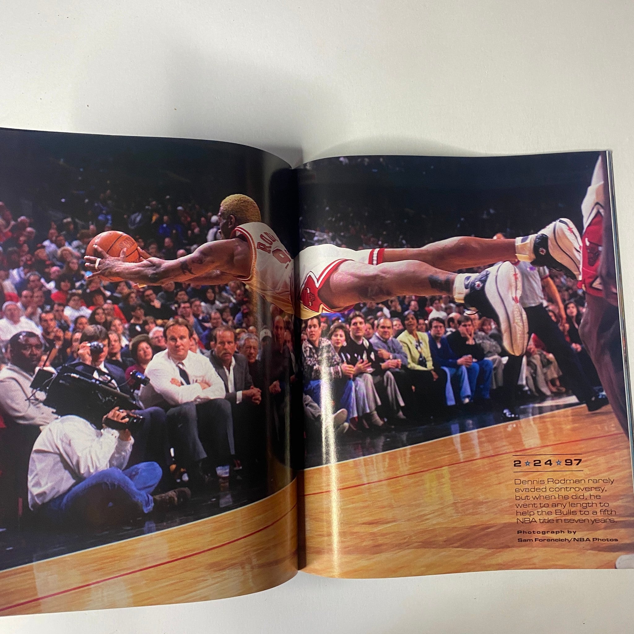 Inside page of Sports Illustrated Magazine - Tiger Woods YEAR IN PICTURES 1997, depicting Dennis Rodman in mid-air during a basketball game, illustrating an unforgettable athletic moment.