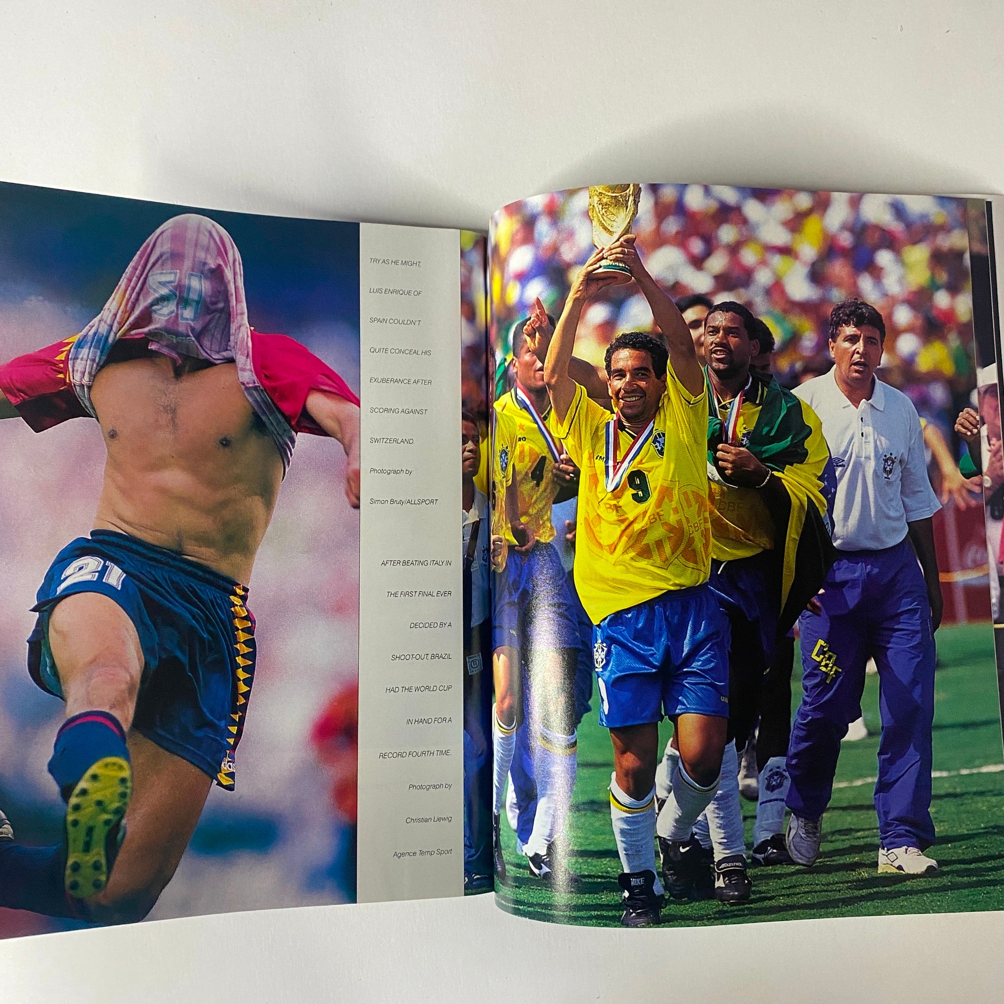Sports Illustrated Magazine 1994 Year in Pictures featuring a celebratory moment from the FIFA World Cup with players holding the trophy, highlighting iconic soccer history.