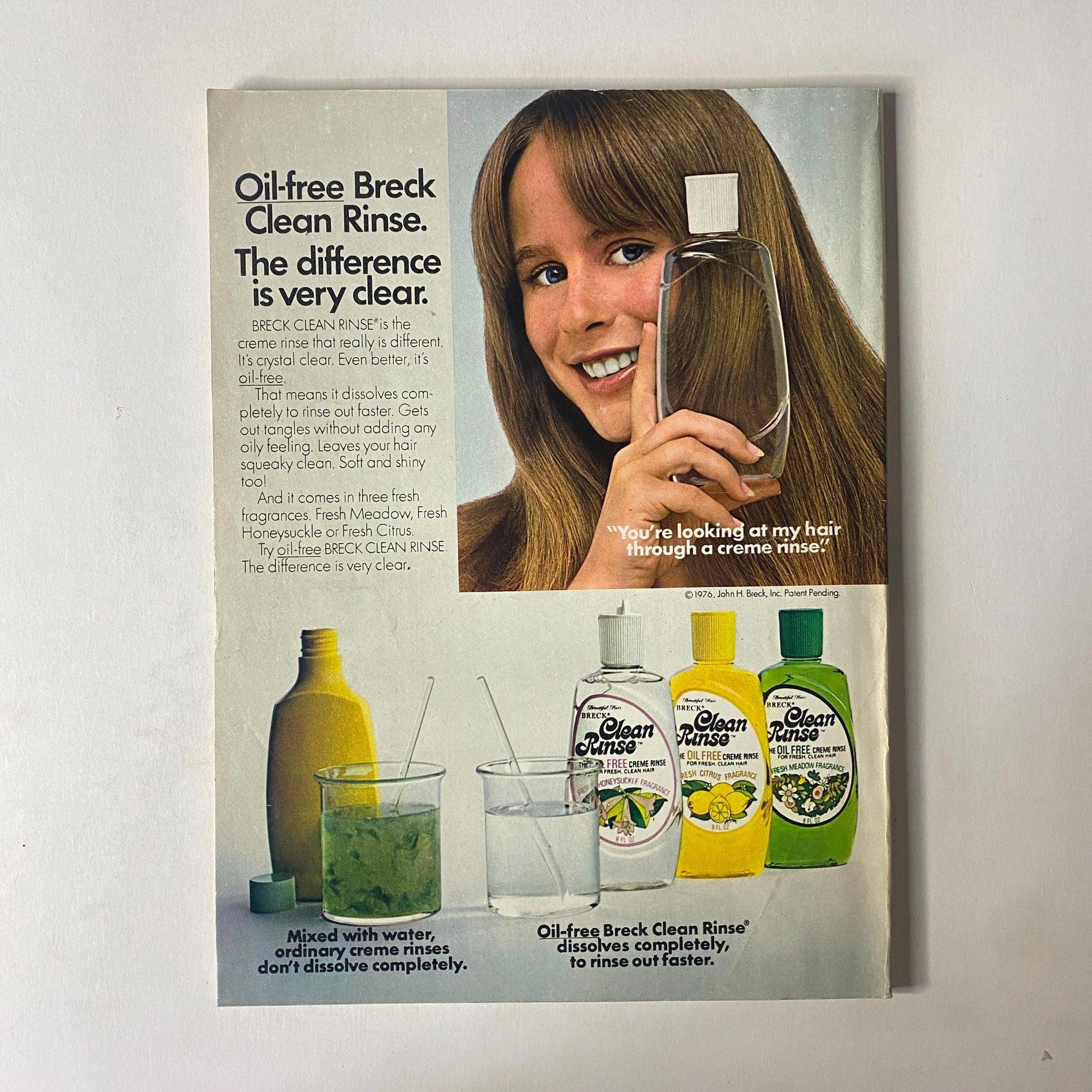 Vintage advertisement for Breck Clean Rinse featuring a smiling woman holding the product, demonstrating its oil-free formula. Emphasizes the difference it can make in hair care. Part of the Seventeen Magazine March 1978 issue featuring Donald McLean as Cover-Boy Winner.