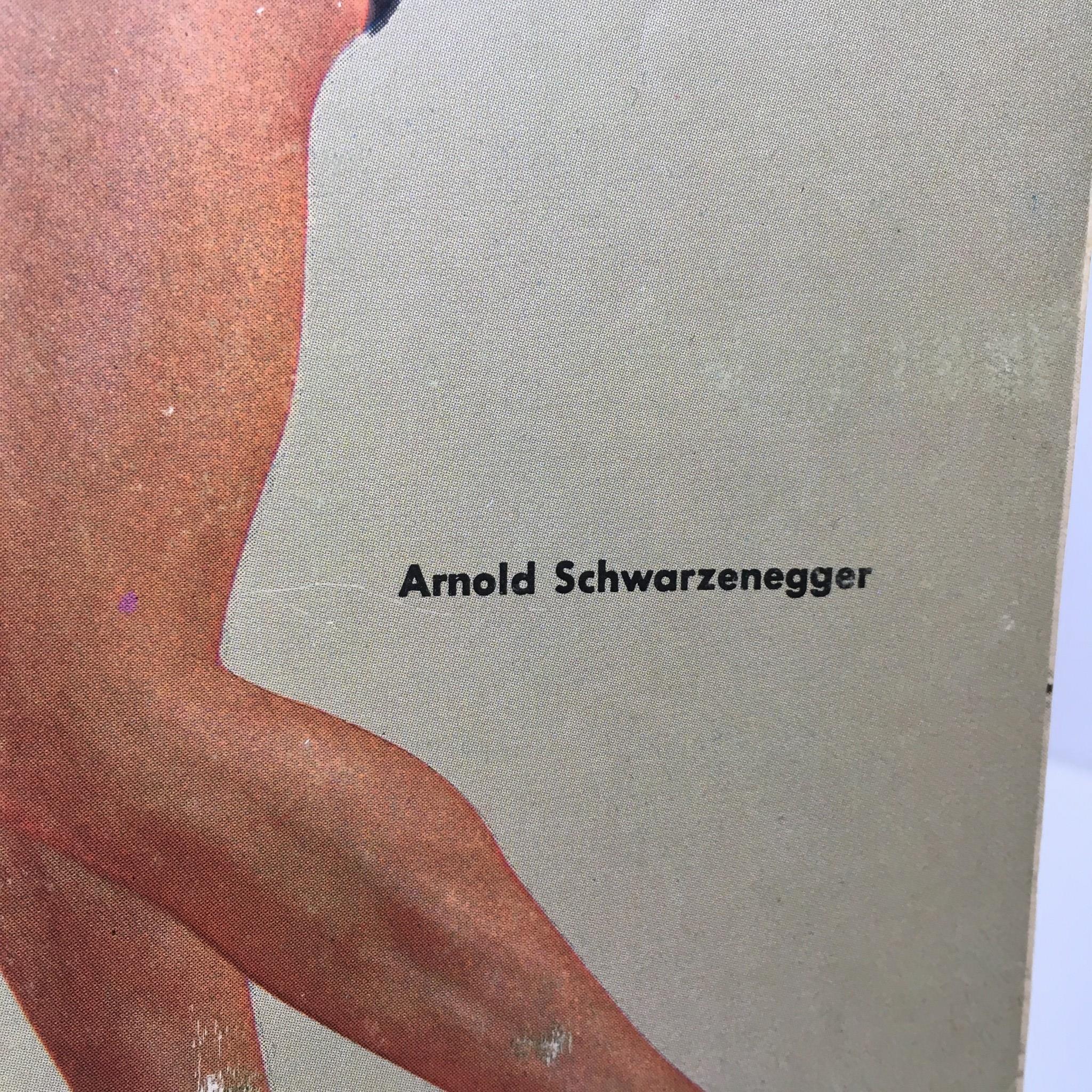 Close-up of the Muscular Development Magazine featuring Arnold Schwarzenegger from August 1967, showcasing his name prominently on the cover.