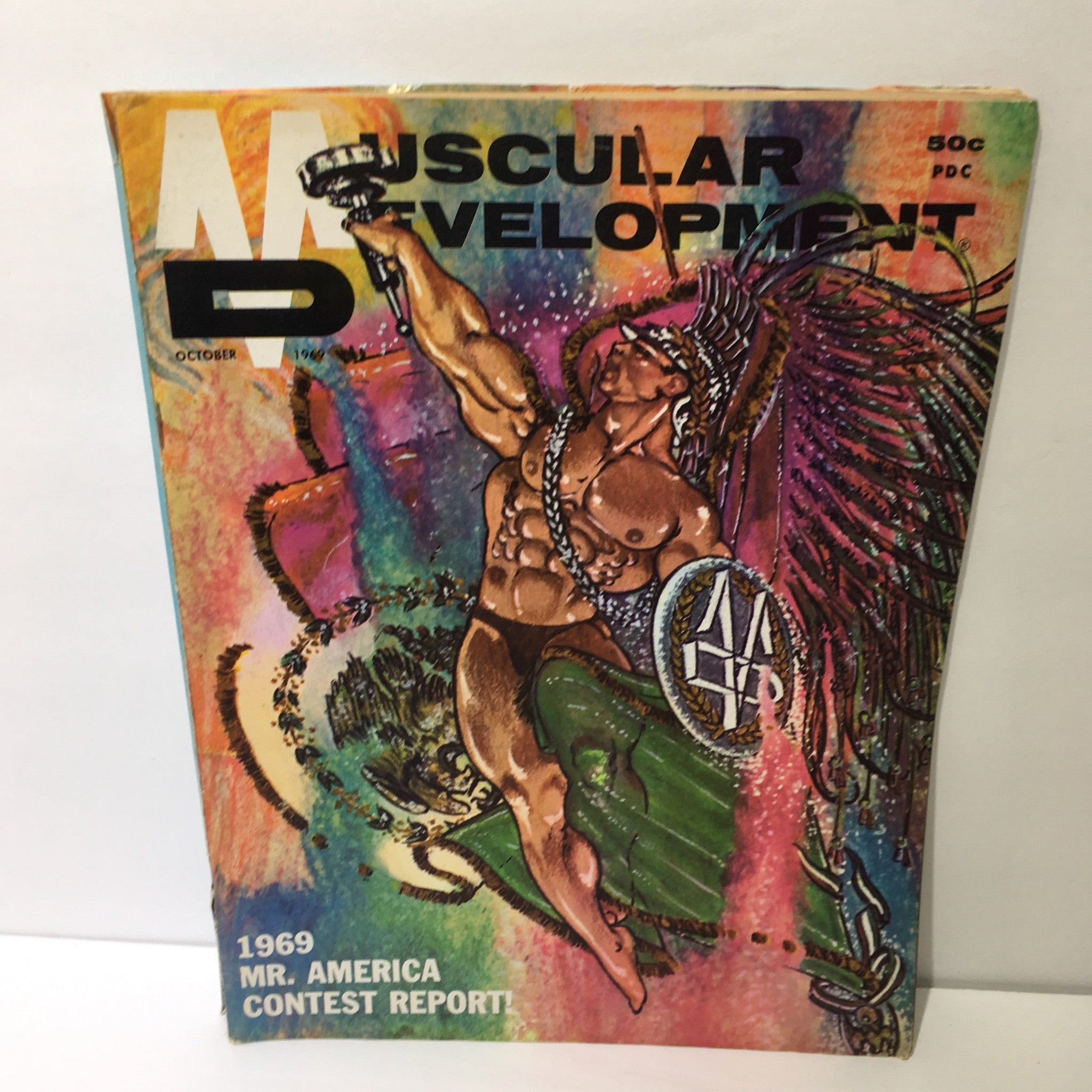 Cover of Muscular Development Magazine featuring an artistic illustration of a bodybuilder for the 1969 Mr. America Contest Report, showcasing vibrant colors and dynamic design.