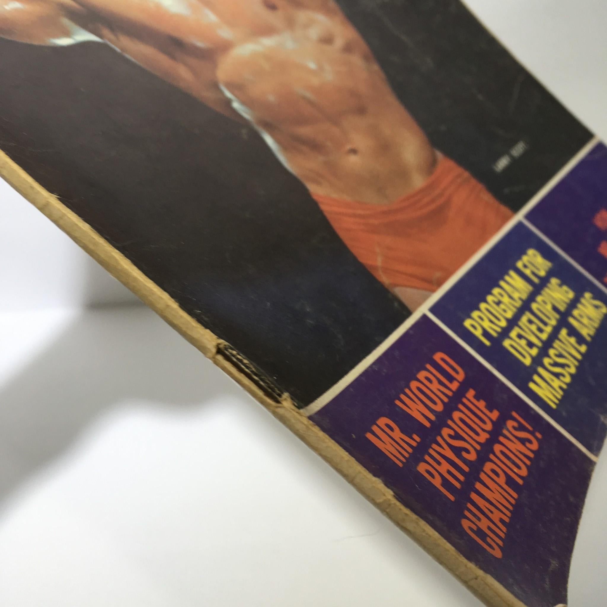 Side view of Muscular Development Magazine July 1966 with visible edge wear, showcasing its authenticity as a collectible item.