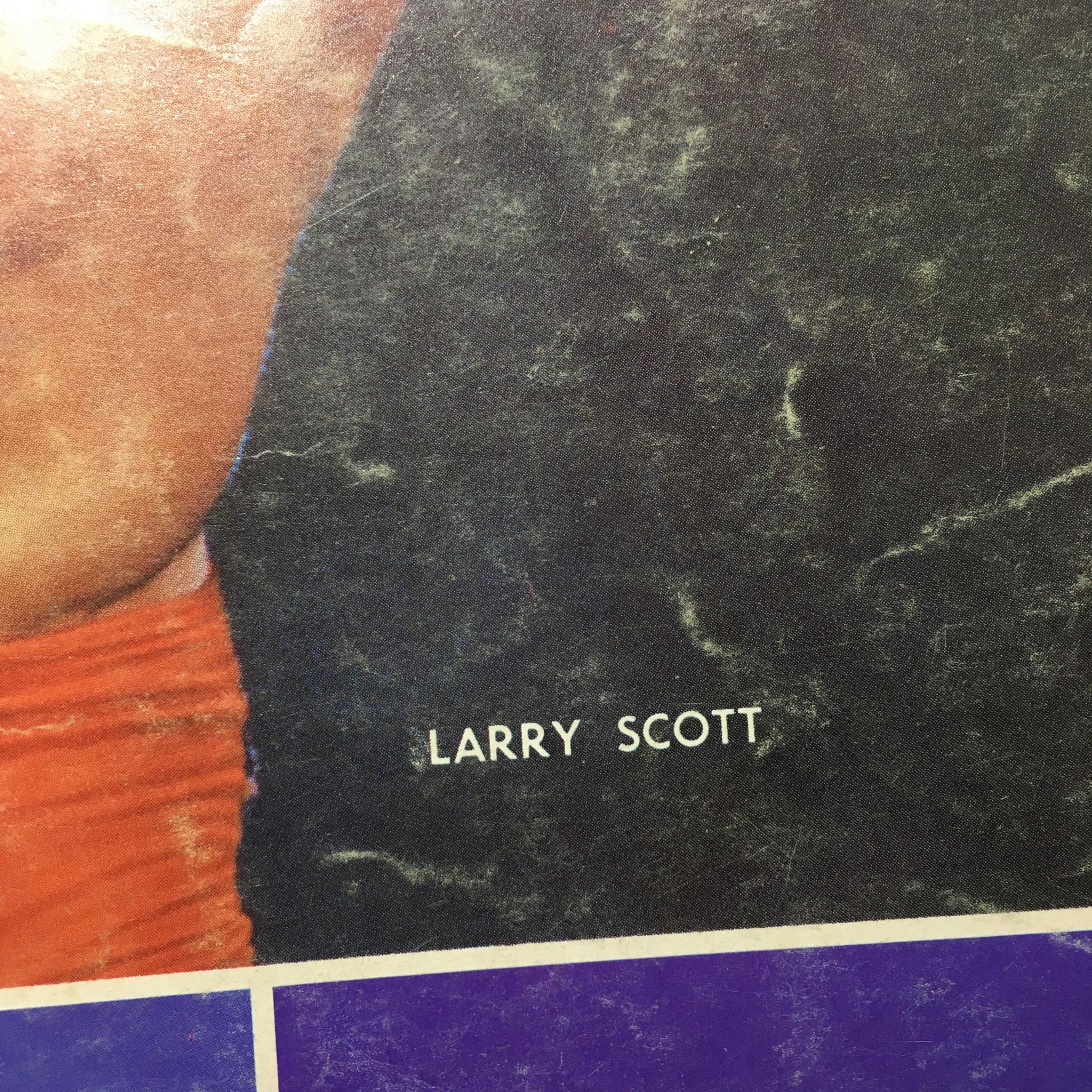 Close-up view of the name 'Larry Scott' featured on the iconic cover of Muscular Development Magazine, July 1966 edition.