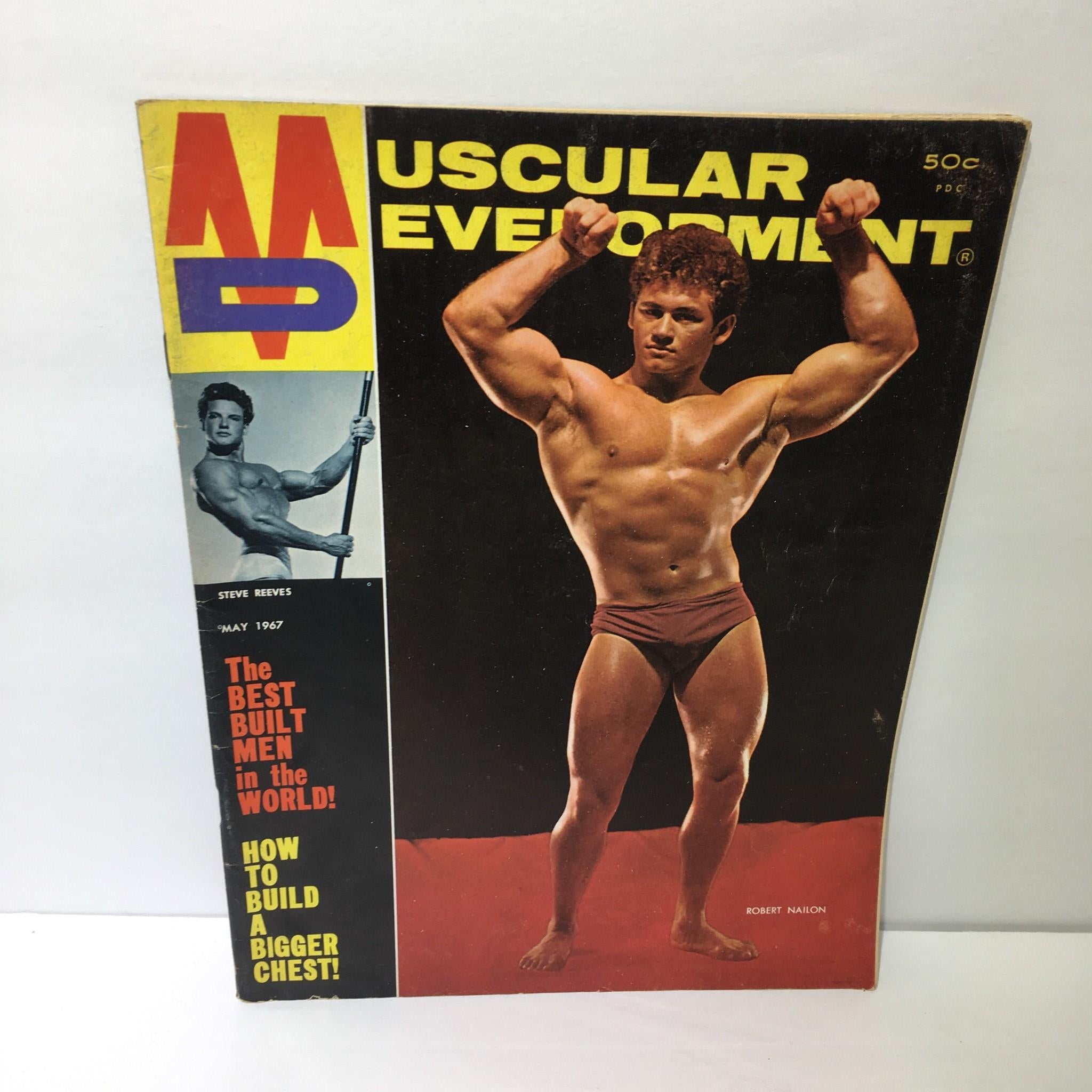 Cover of Muscular Development Magazine featuring Robert Nailon, May 1967. The cover highlights bodybuilding culture with an image of a muscular man posing, alongside Steve Reeves and bold text on workout guidance.