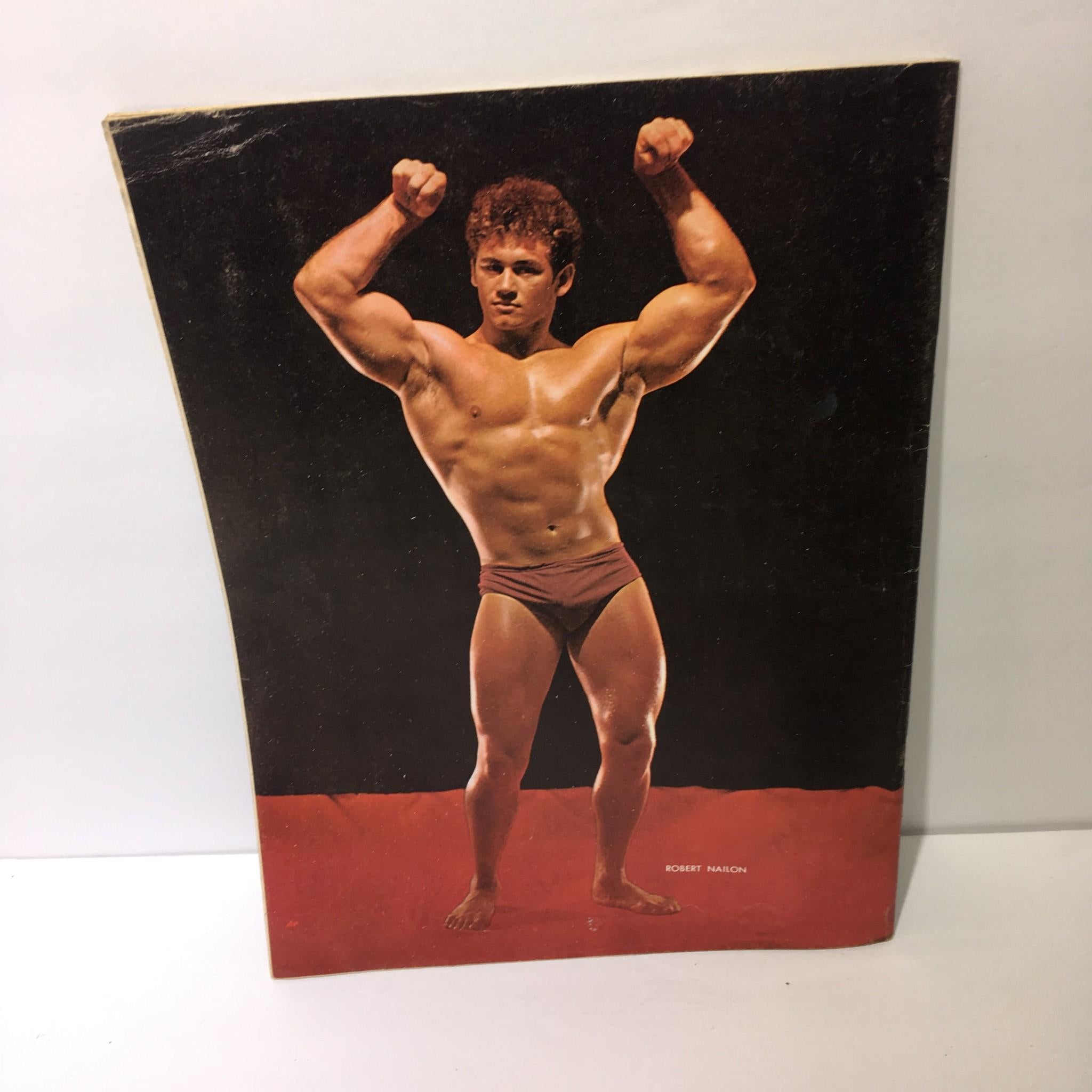 Back cover of Muscular Development Magazine May 1967 showcasing Robert Nailon in a bodybuilding pose on a red background.
