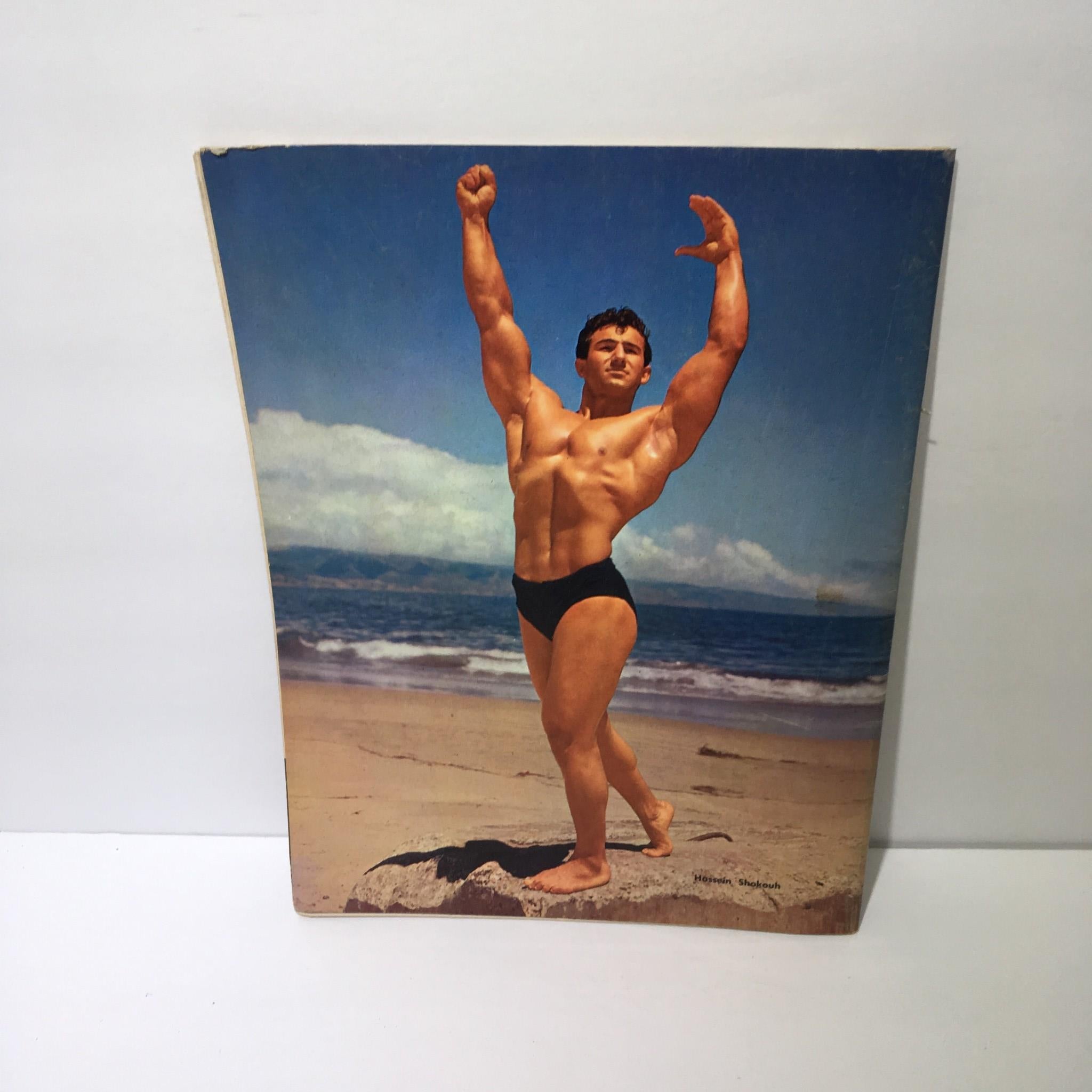 Muscular Development Magazine June 1967 cover showing Hossein Shokouh flexing on a beach.