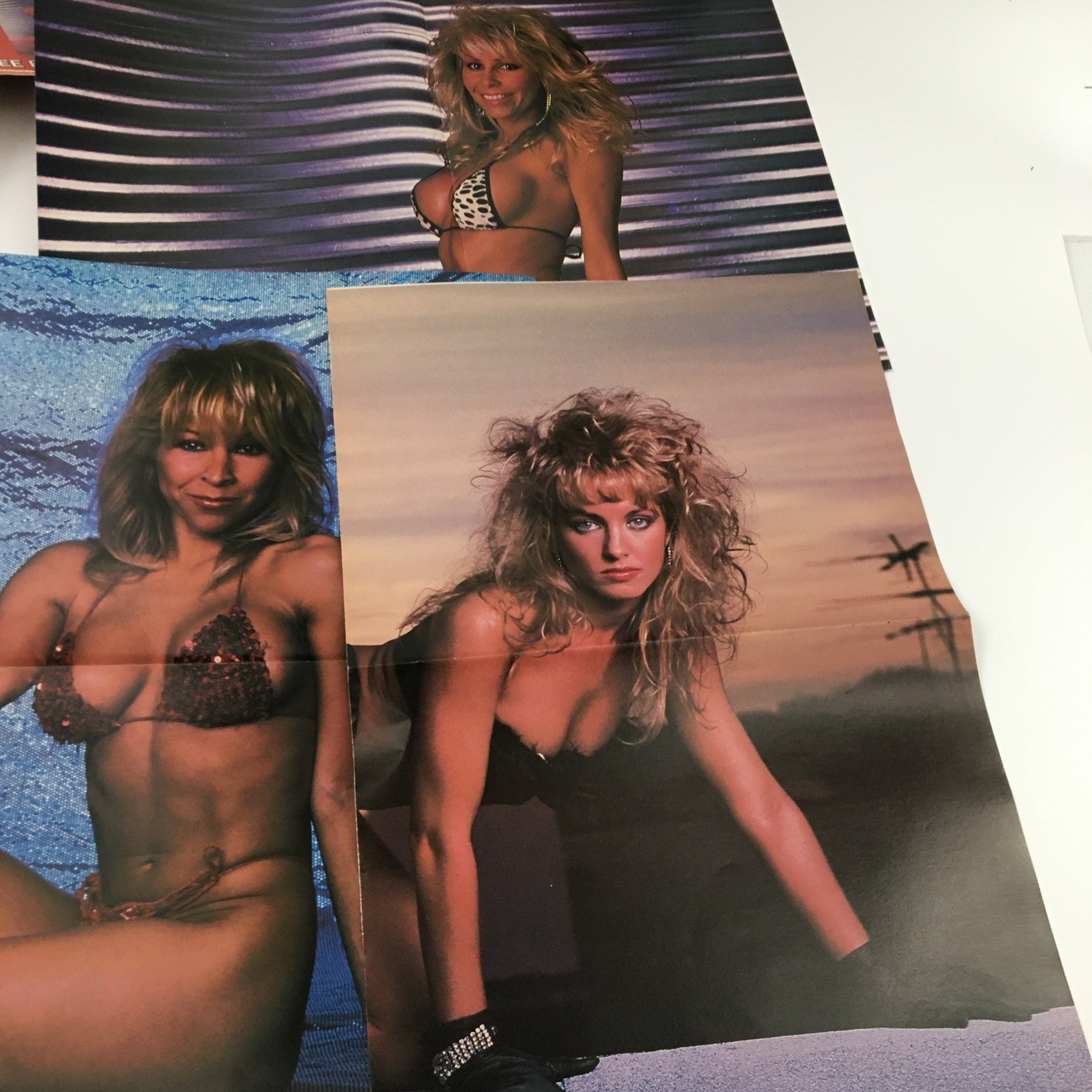 Colorful collaged posters from Blast Swimsuit Posters Magazine 1986 Ashley Series featuring sultry models in 1980s swimwear against vibrant backdrops.