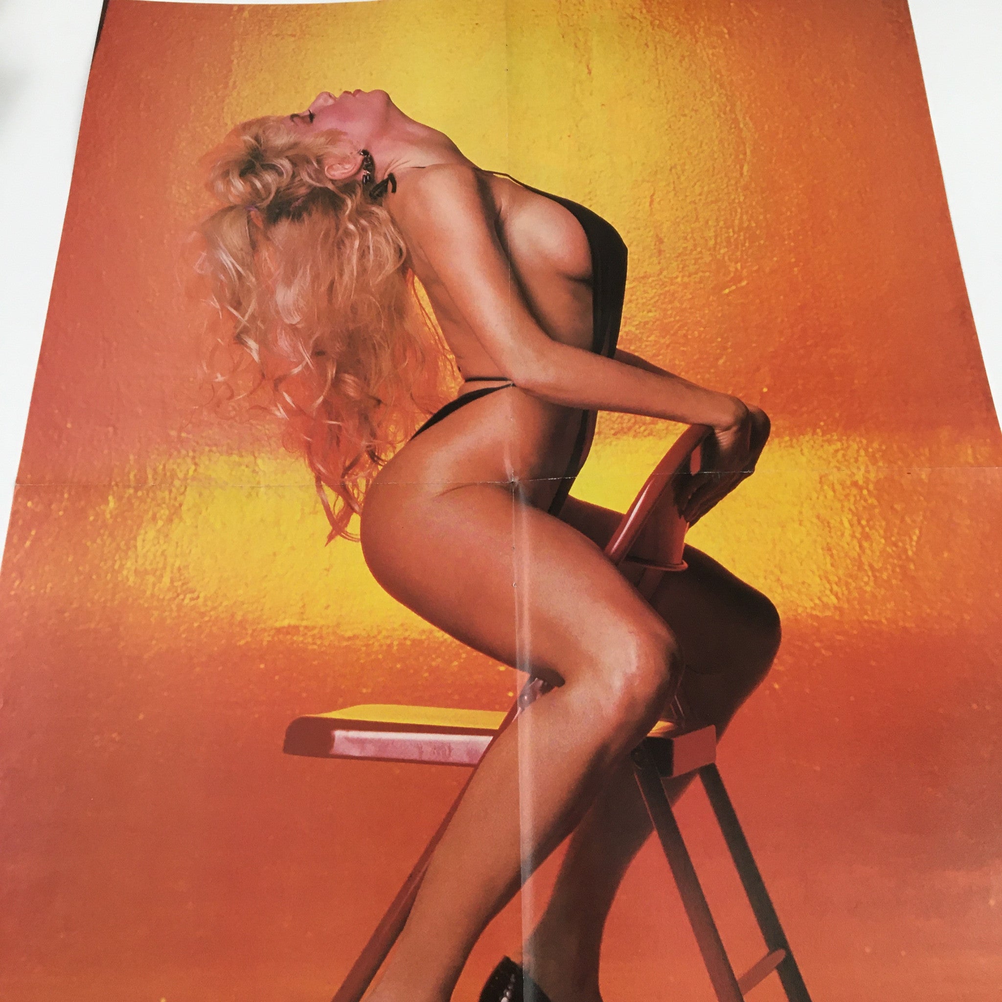 Striking photo of a model in a black swimsuit, showcasing glamorous styling from Blast Swimsuit Posters Magazine 1986 Ashley Series.